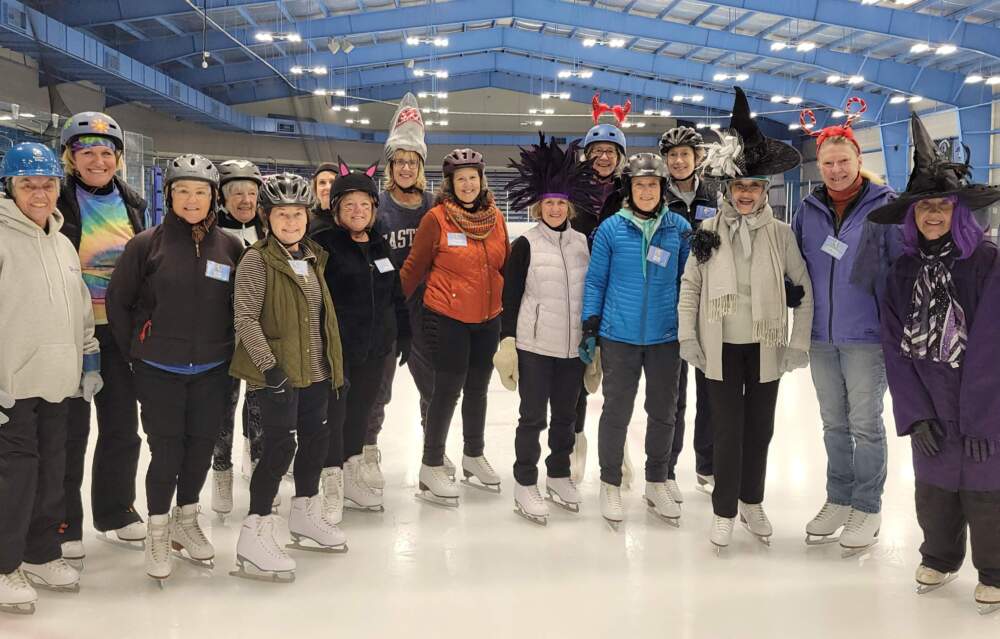 The author, second from right in the back row with red devil horns, with her skating class and Dottie, far right with purple hair on Halloween in 2025. (Courtesy Ann MacDonald)