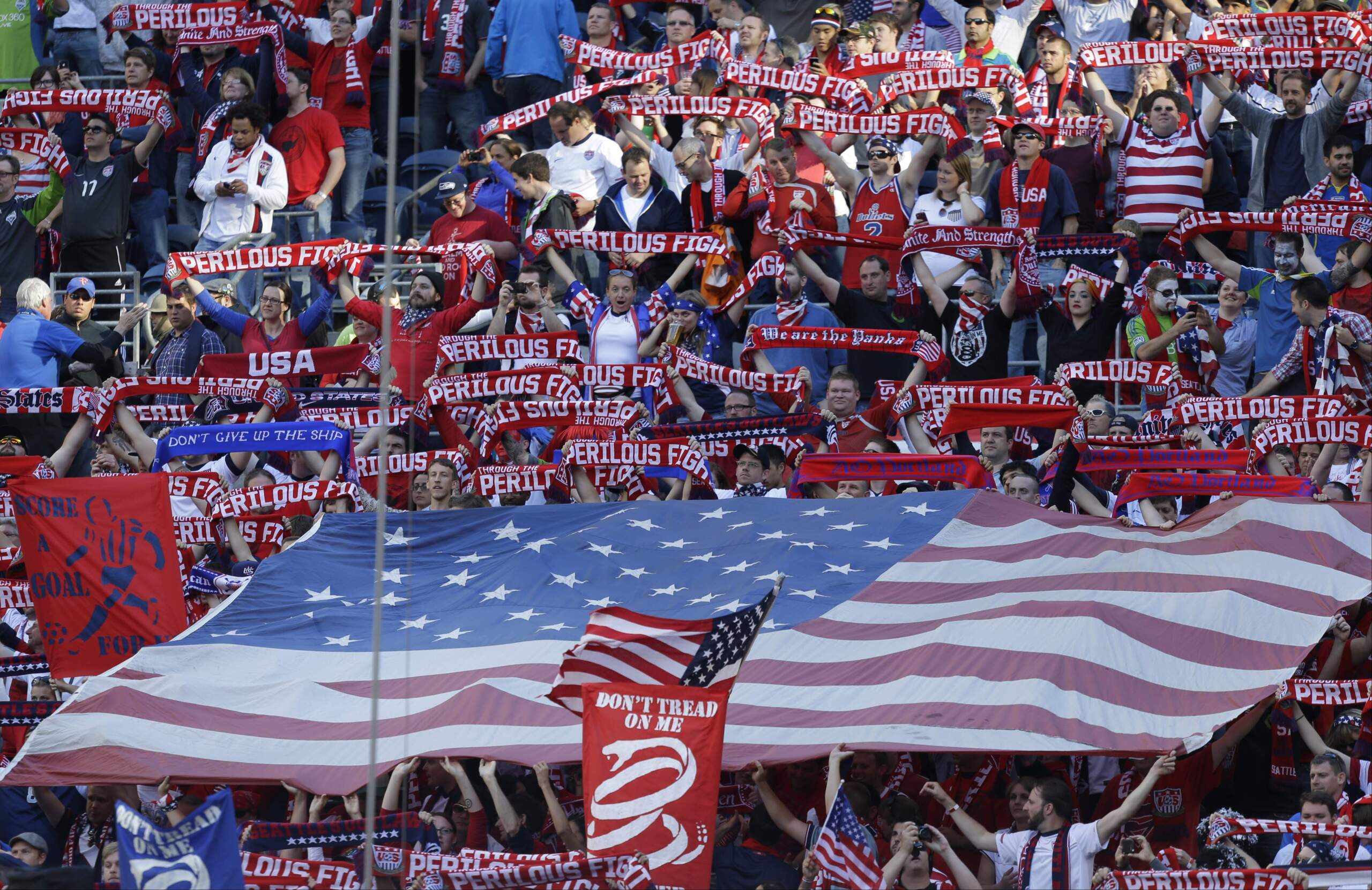 USA soccer fans hold up supporters scarves and flags at CenturyLink Field prior to a World Cup qualifier soccer match between USA and Panama on June 11, 2013, in Seattle. (Ted S. Warren/AP)
