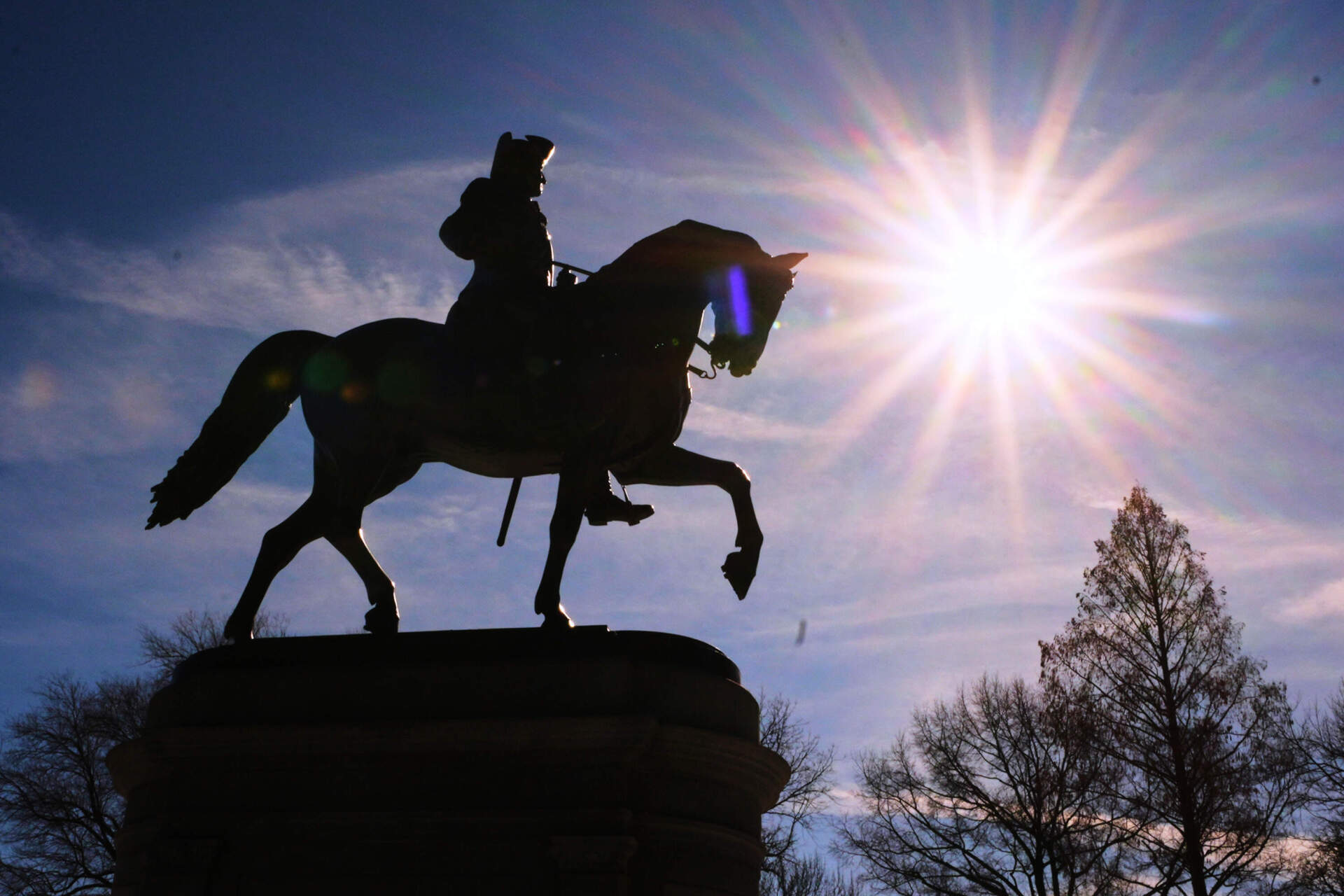 The sun shines over a statue of George Washington on horseback at the Public Garden on Feb. 13 in Boston. (Charles Krupa/AP)