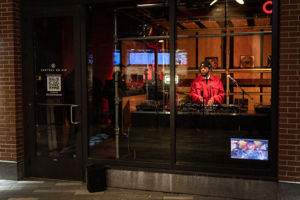 Seen from the Market Central walkway, DJ MEZ.WAV spins a set live for Central on Air. (Robin Lubbock/WBUR)