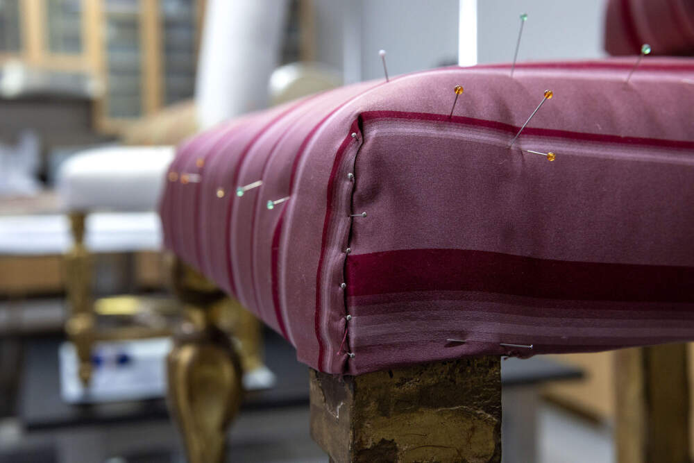 Pins hold new upholstery in place on one of the Gardner Museum's chairs during restoration. (Robin Lubbock/WBUR)