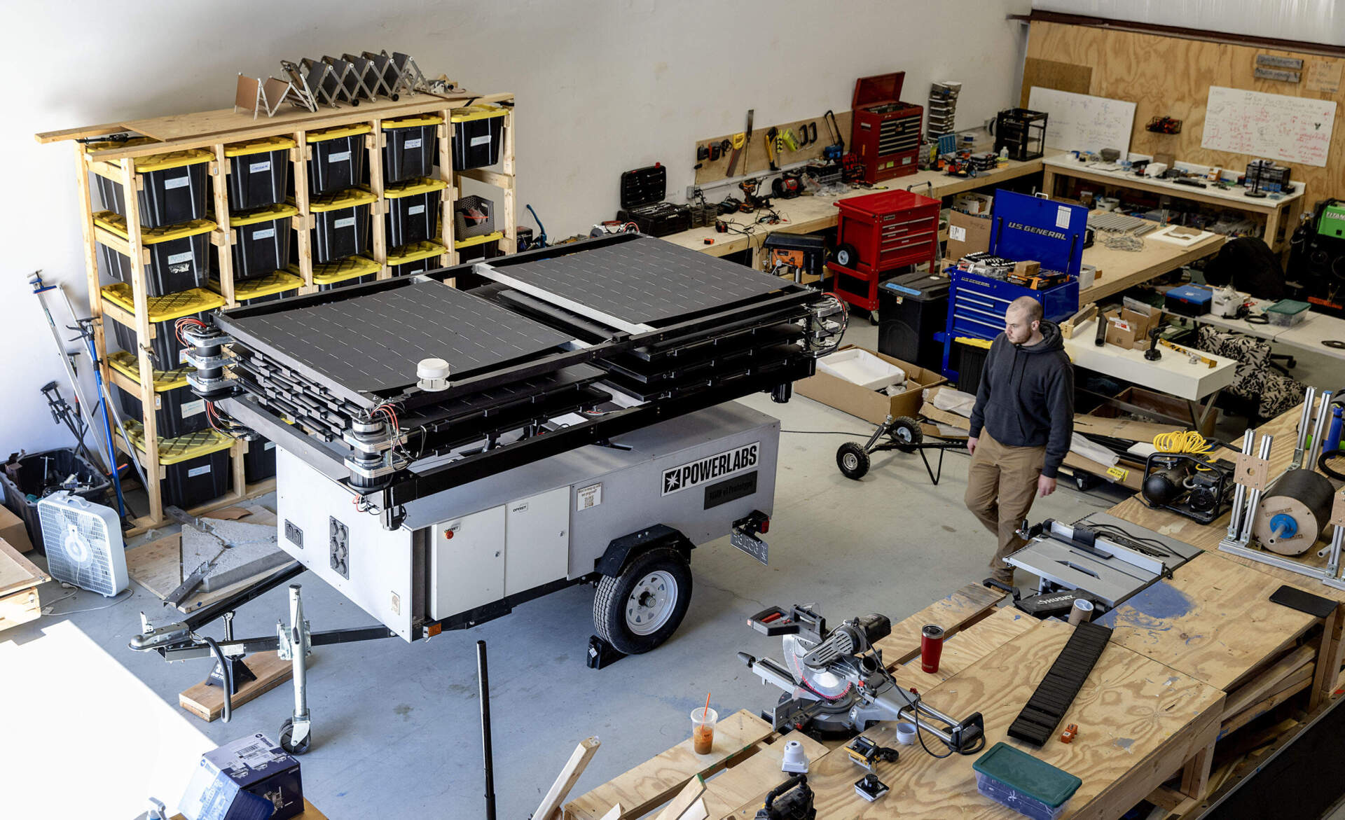 A PowerLabs solar generator trailer sits, folded up, inside the work space of the company's workshop in Beverly, Mass. (Robin Lubbock/WBUR)