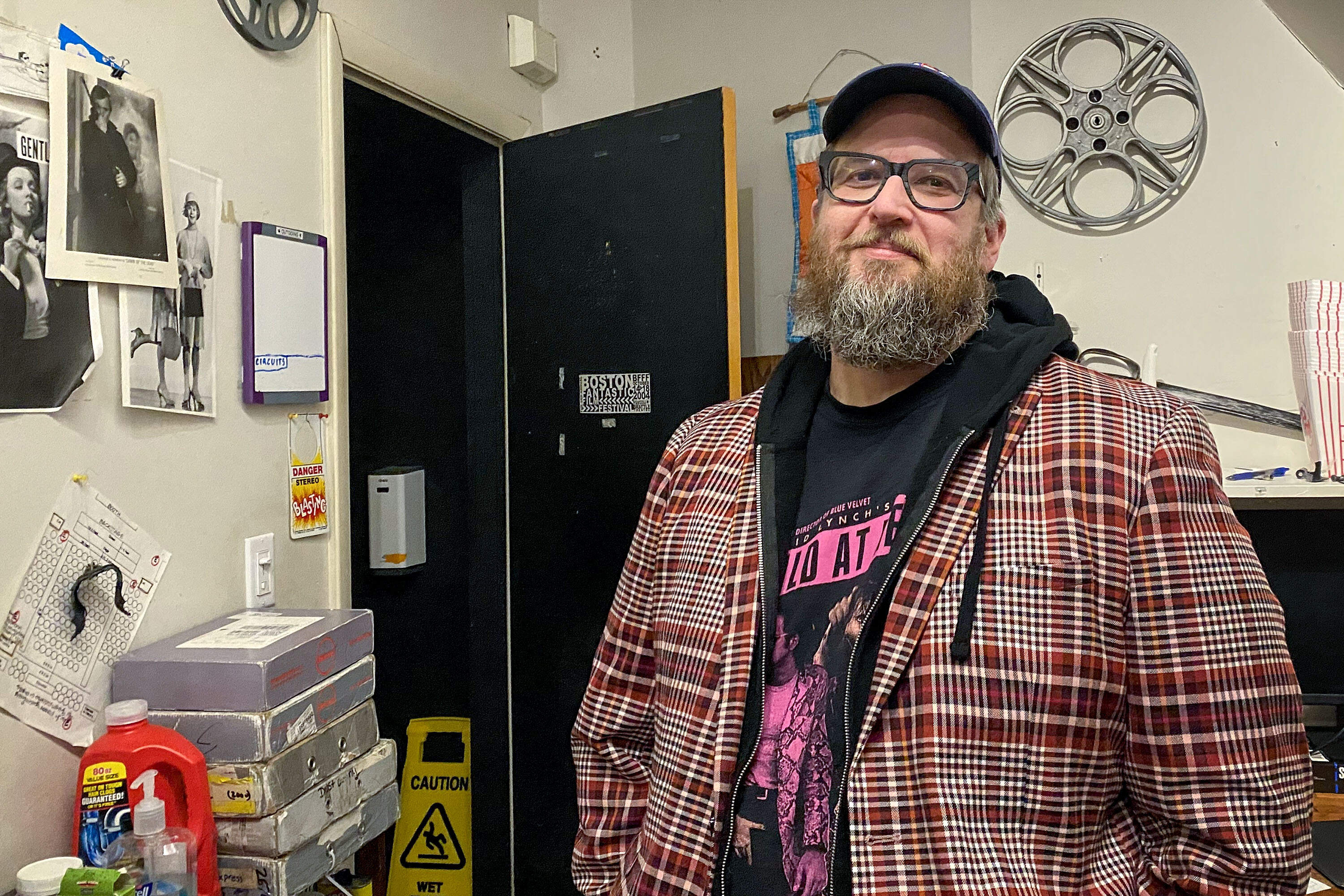 “When you can see a little bit of residue of history, you’re really connecting to everybody who's ever watched that particular print over its existence,” says Brattle creative director Ned Hinkle. (Andrea Shea/WBUR)