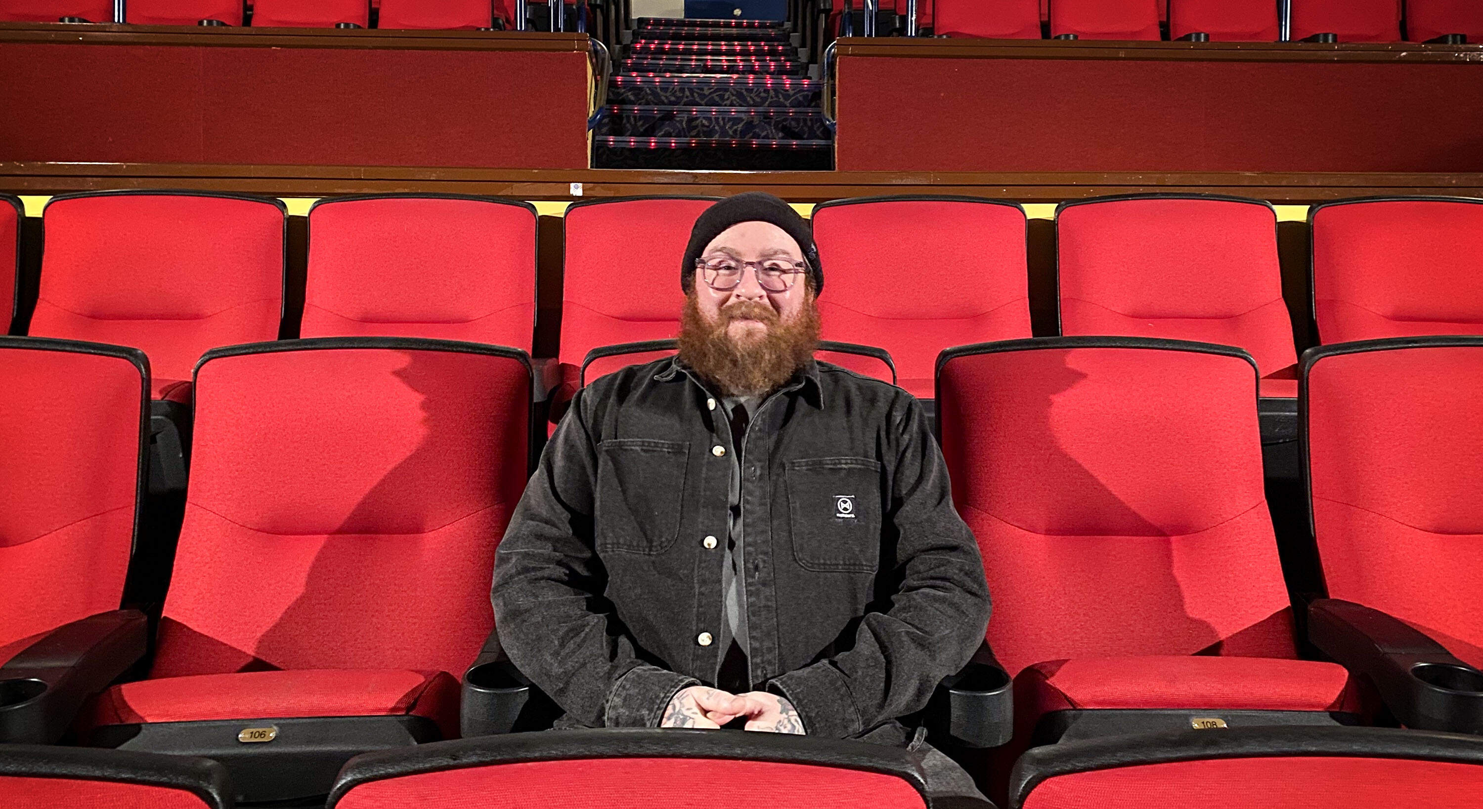 Coolidge Corner Theater artistic director Mark Anastasio sits in Moviehouse 2 at the cinema. (Andrea Shea/WBUR)