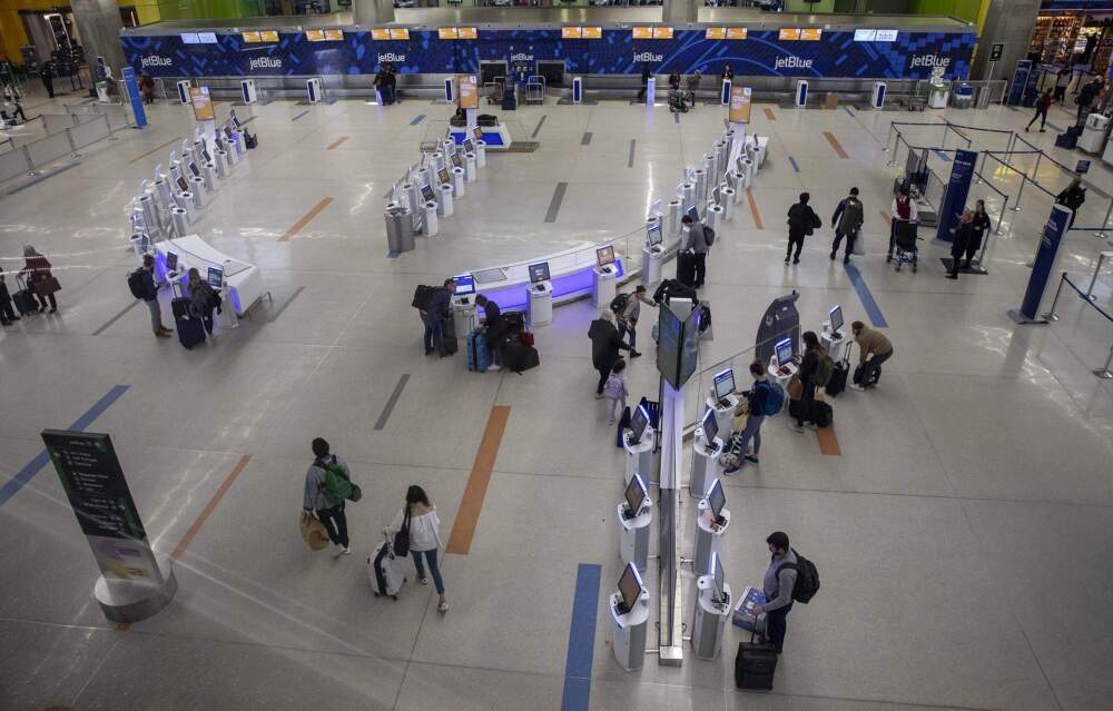 An overhead shot of passenger traffic through the JetBlue check-in area at Logan Airport in 2020. (Robin Lubbock/WBUR)