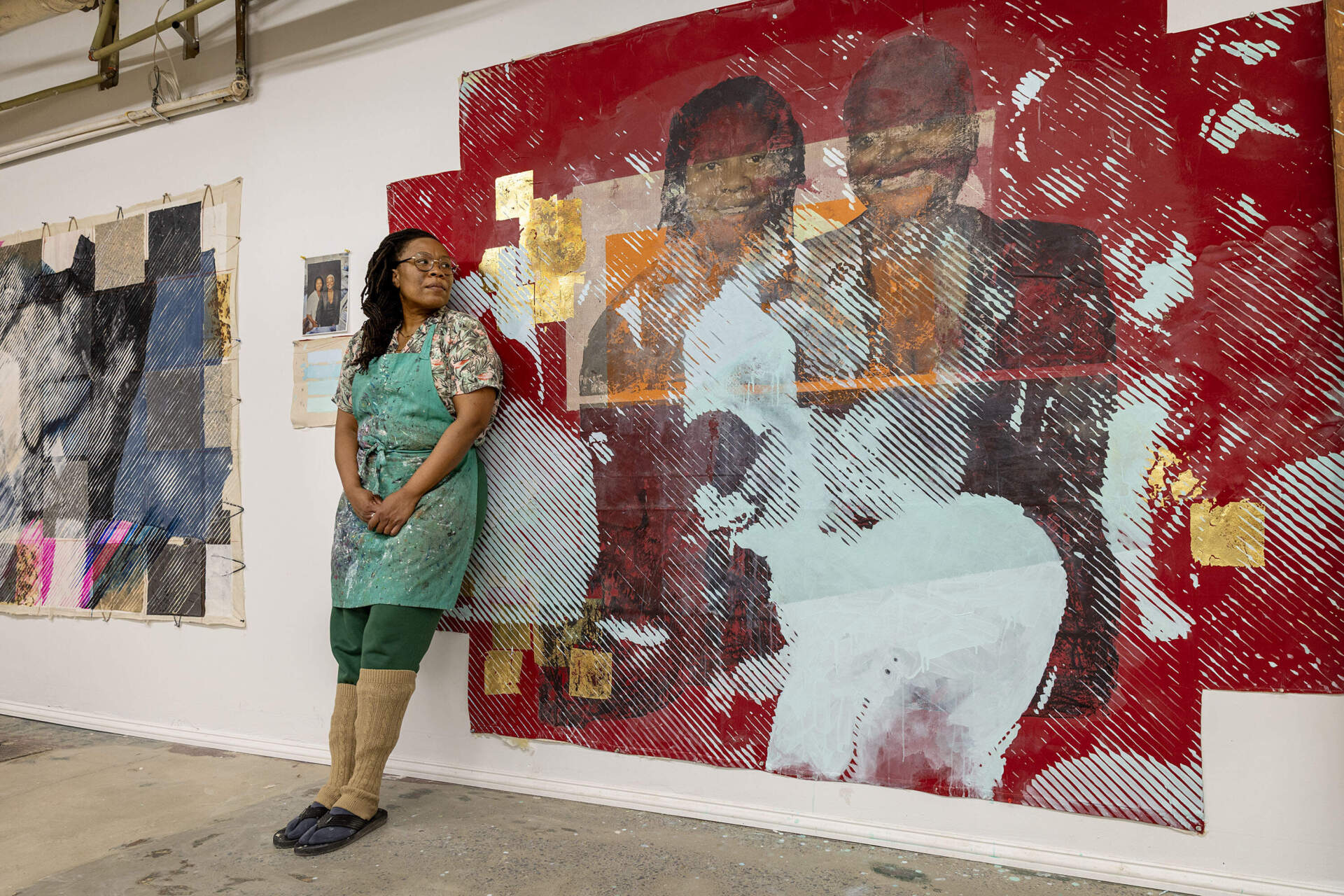 Artist Tomashi Jackson leans against the wall of her studio in Somerville by "Sister Outsider (Aver and April and the Dancefloor)." (Robin Lubbock/WBUR)