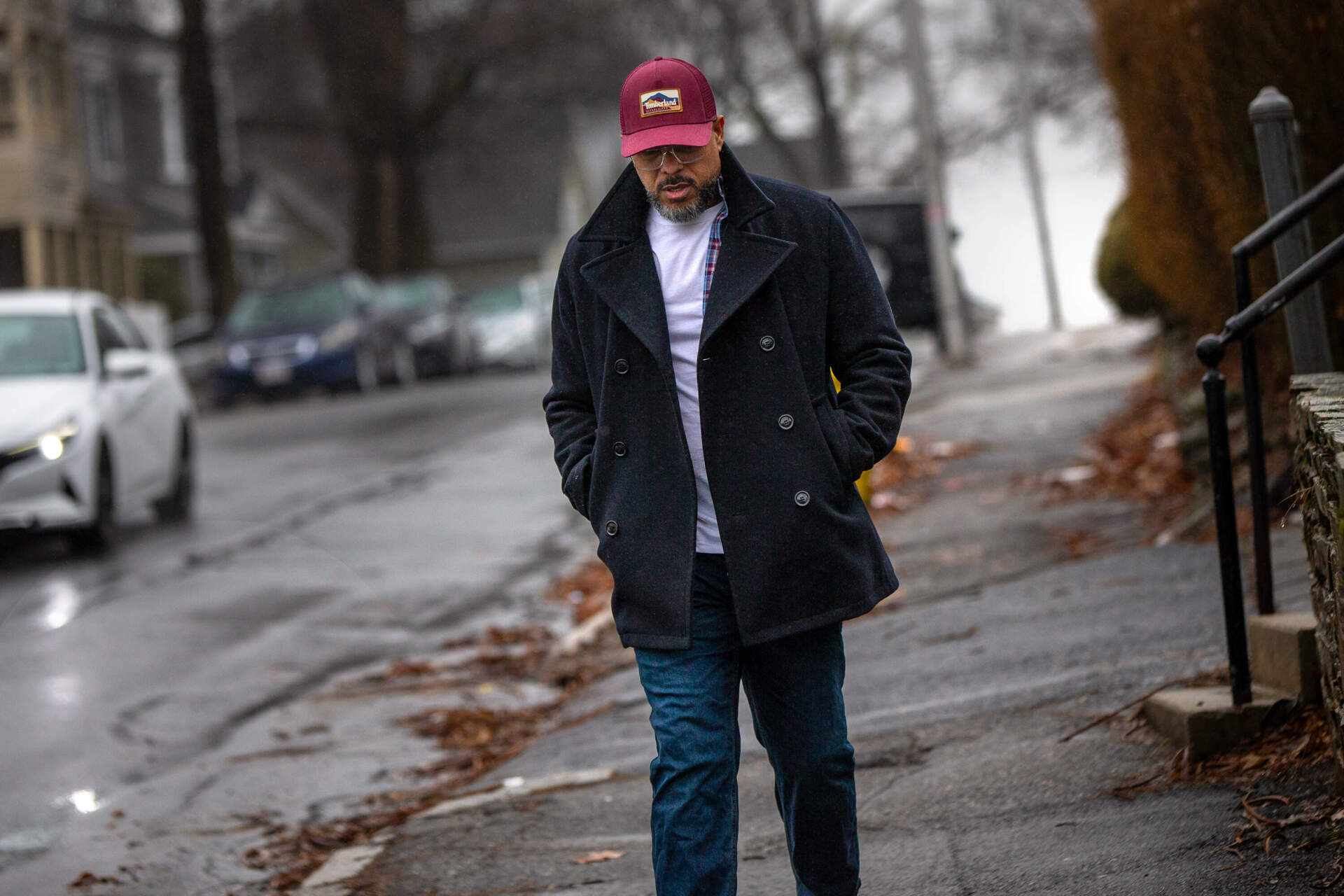 Robert Francis walks in the rain to catch the bus to attend an AA meeting in downtown Worcester. Though he has no history of substance abuse, he is required to attend AA meetings in order to stay at Dismas House. (Jesse Costa/WBUR)