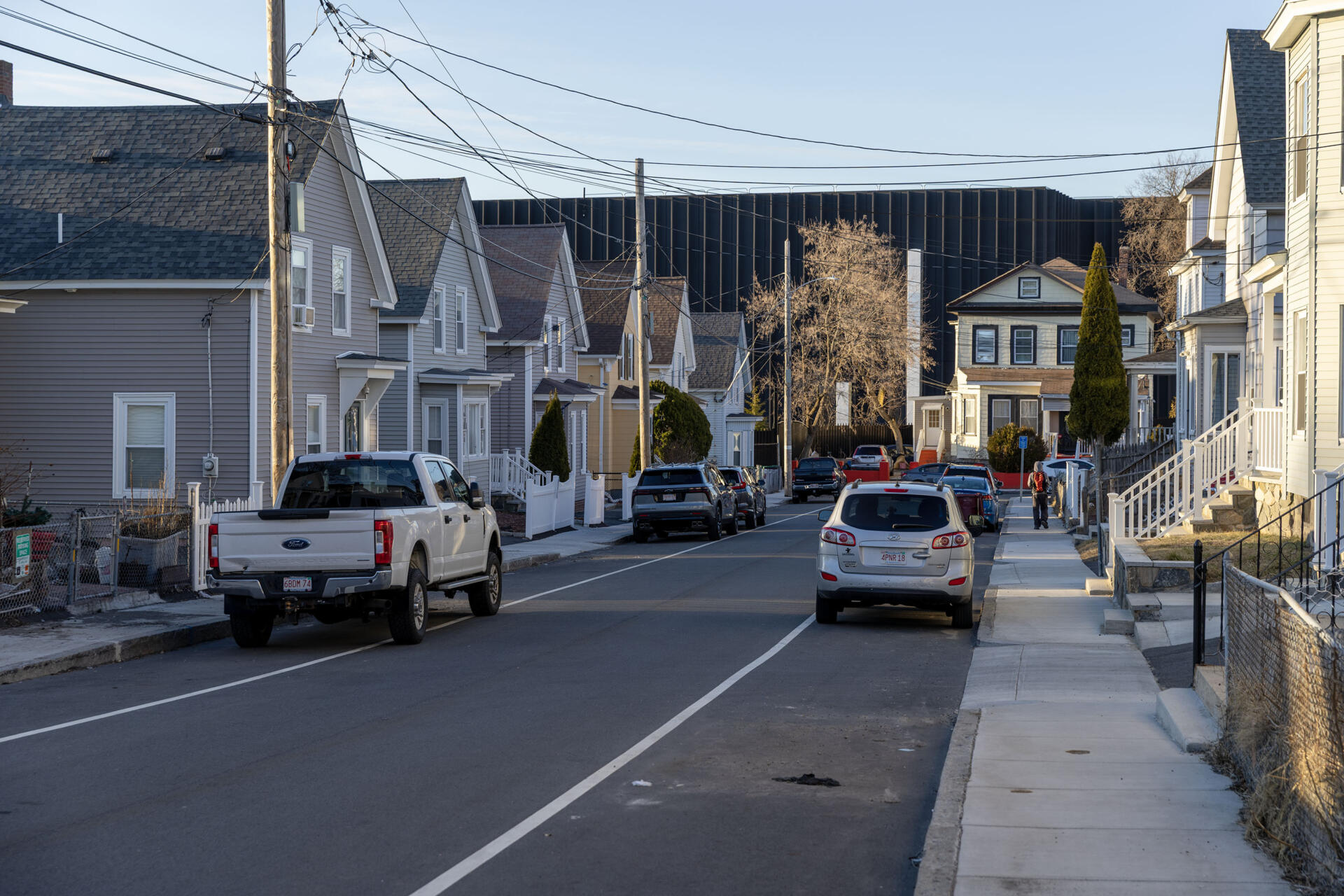 The Markley data center rises above houses on Otis Street, in Lowell, Mass. (Robin Lubbock/WBUR)