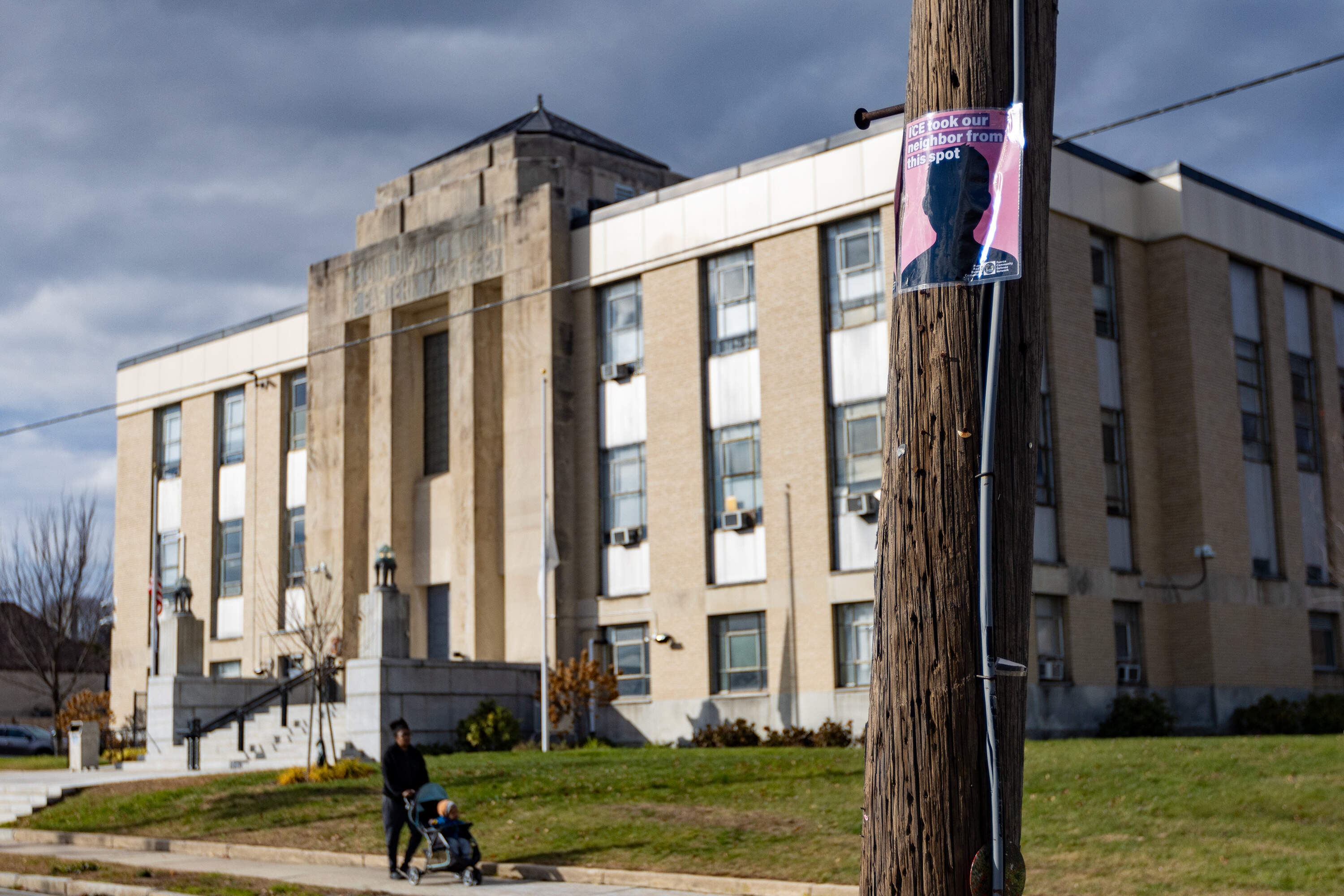 A poster from the Fuerza Community Defense Network on a telephone poll outside of Waltham District Court warning people of the potential presence of ICE at the courthouse. (Jesse Costa/WBUR)