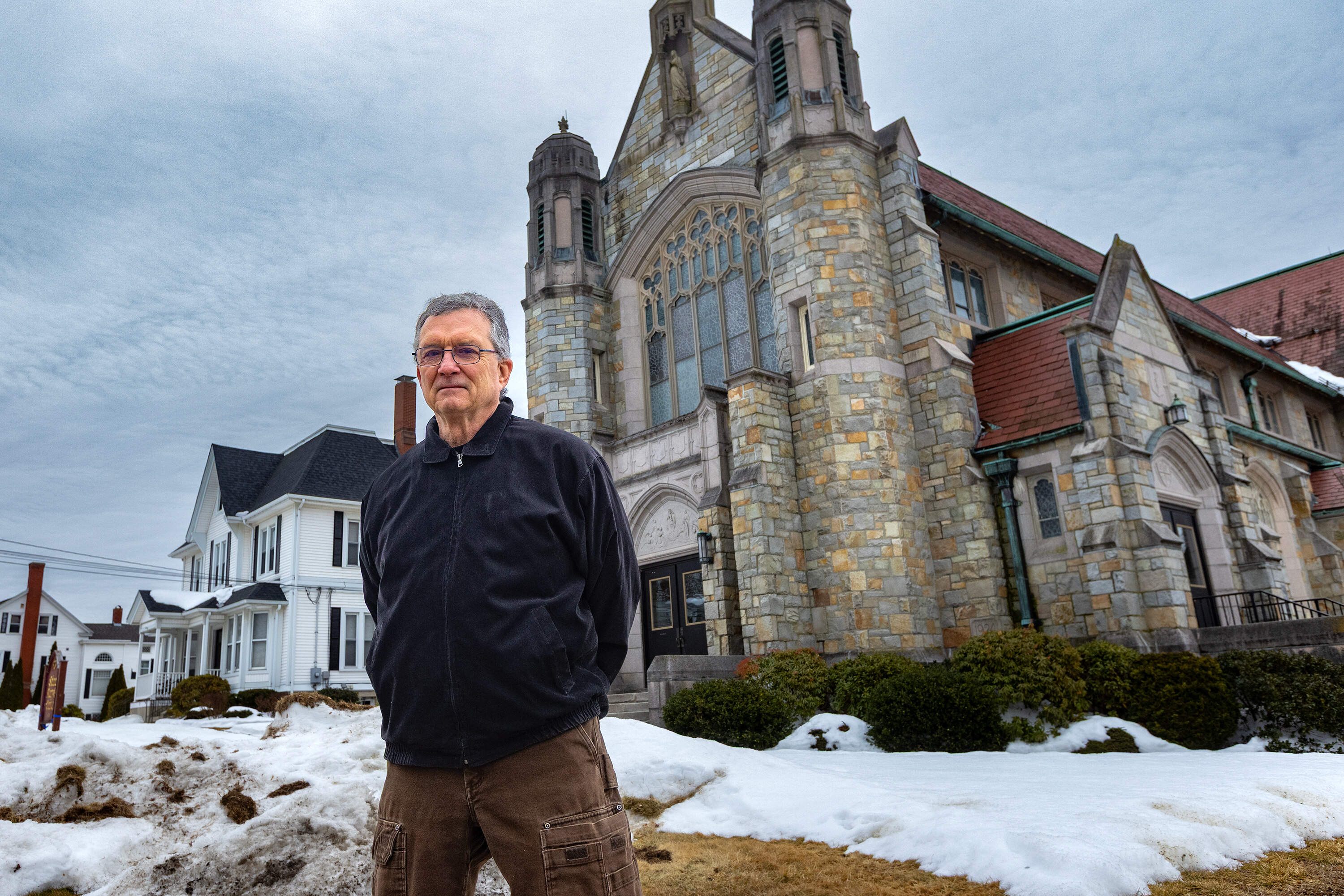 Dave Lewcon standing outside of the St. Mary Catholic Church in Uxbridge where he was sexually abused. (Jesse Costa/WBUR)
