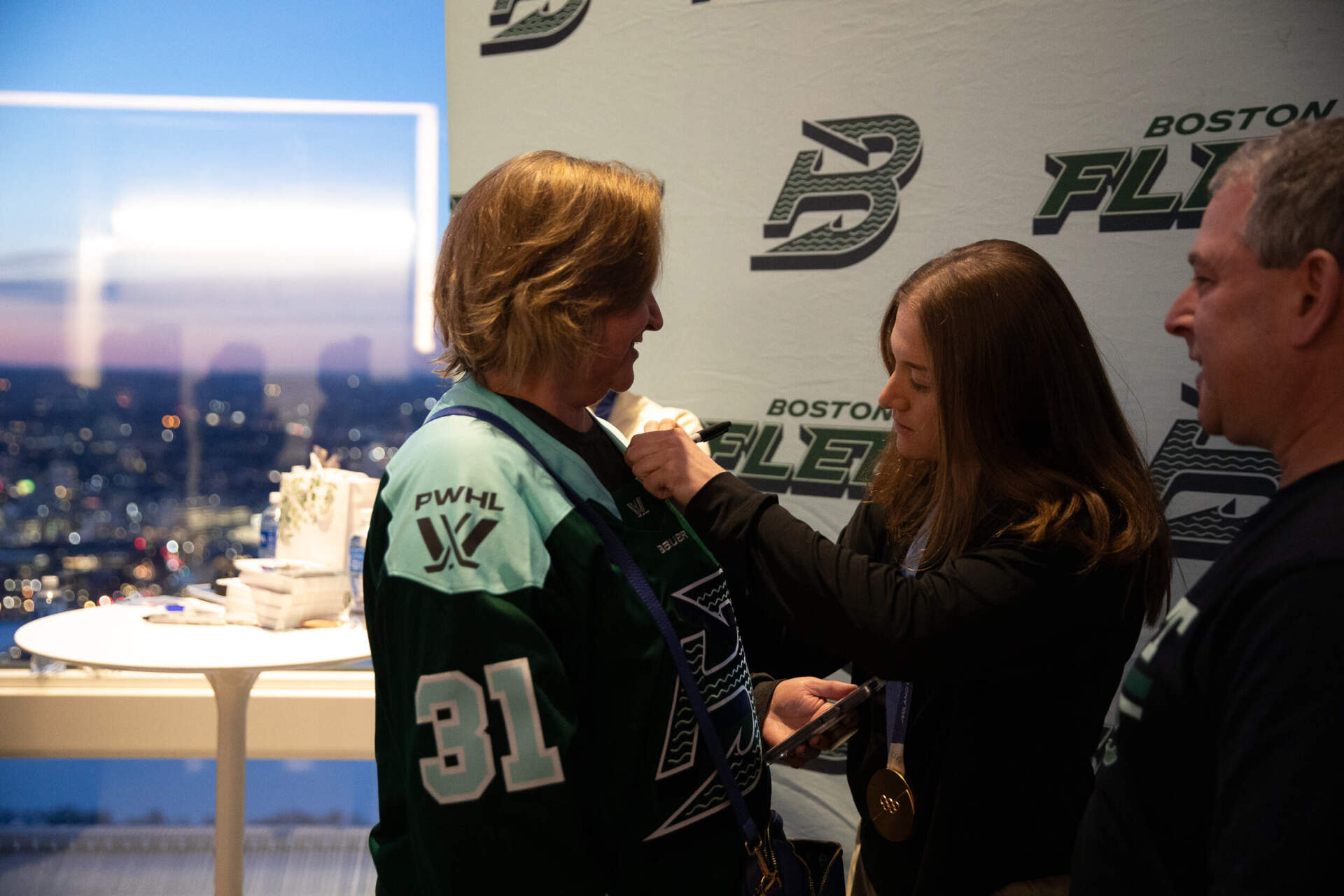 Urszula Caney of Westford gets her jersey signed by Boston Fleet goaltender Aerin Frankel. (Artemisia Luk/WBUR) 