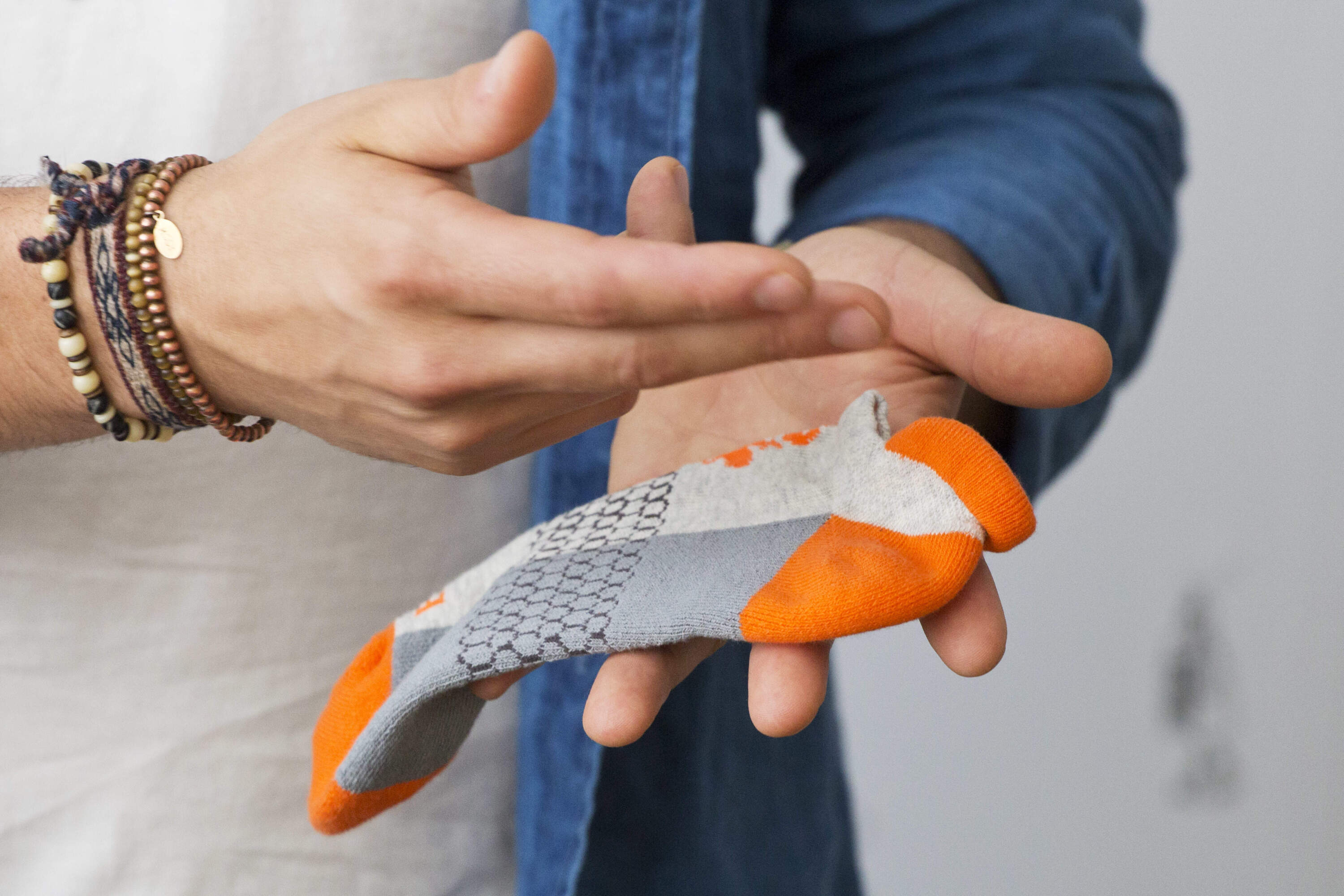 In this June 22, 2018, photo, David Health, CEO and co-founder of Bombas, shows a Bombas sock during an interview in his New York office. (Mark Lennihan/AP)