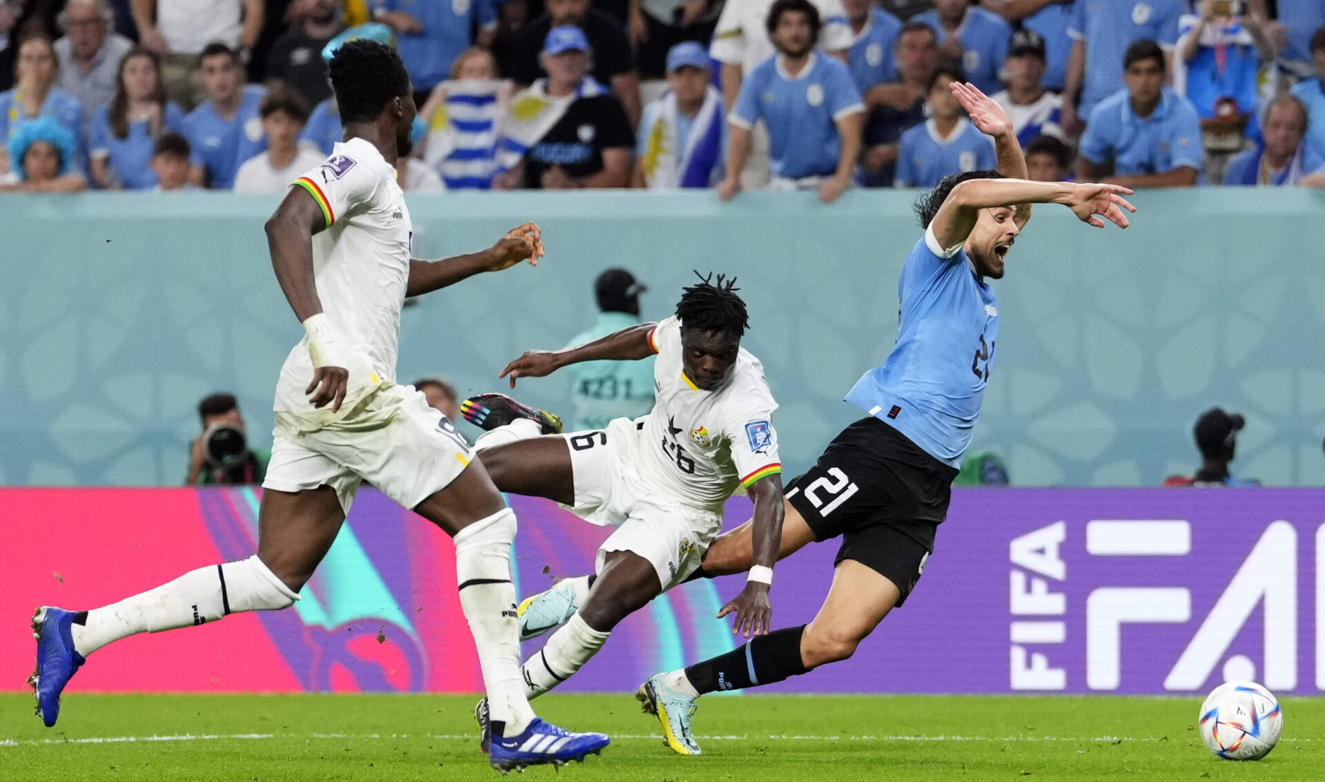 Uruguay's Edinson Cavani, right, falls beside Ghana's Alidu Seidu, the referee decides no penalty during the 2022 World Cup. (Manu Fernandez/AP)