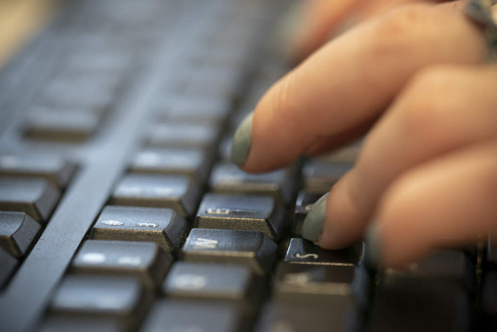In this file photo, a woman types on a keyboard in New York on Oct. 8, 2019. (Jenny Kane/ AP)