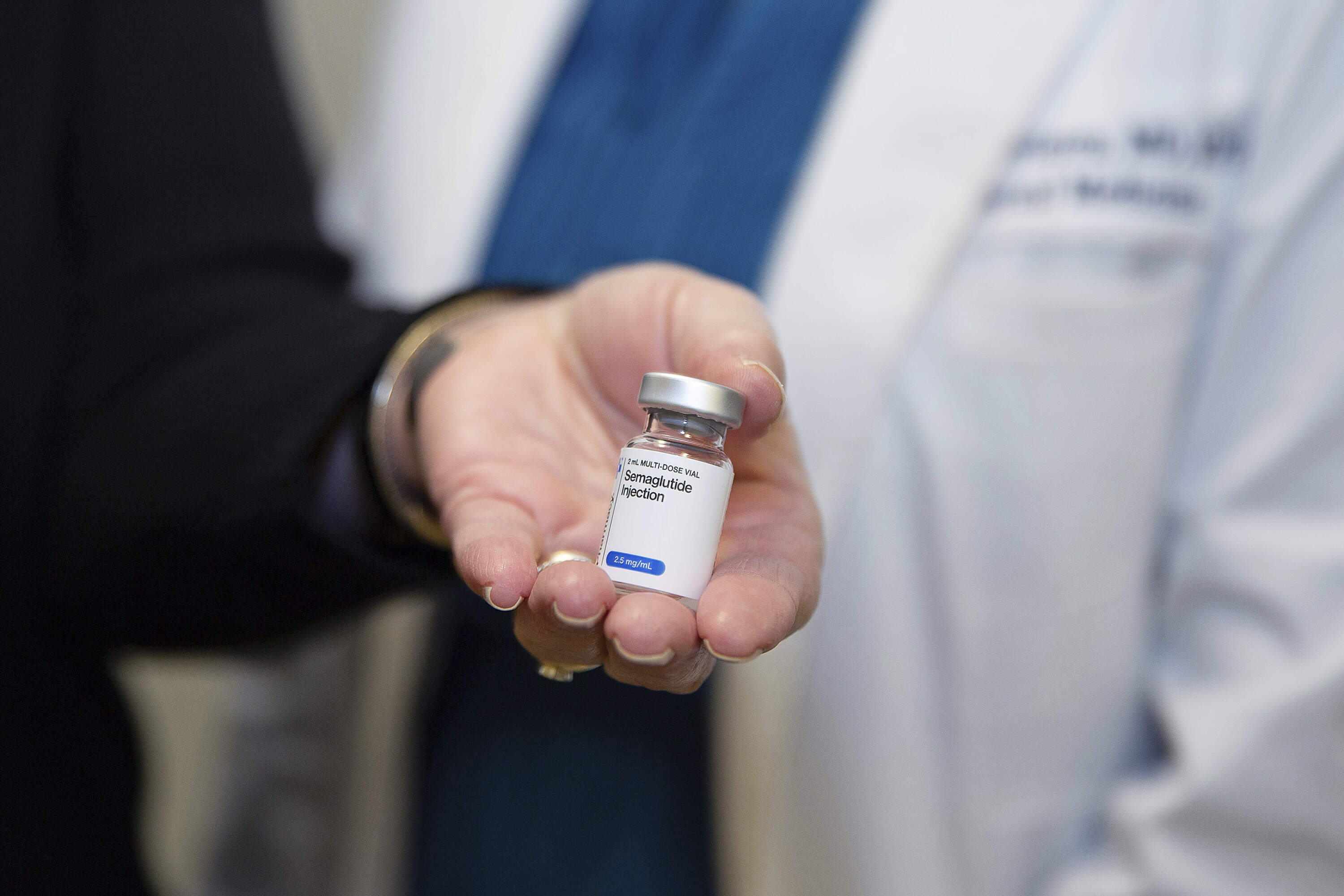 Patient Lory Osborn (left) holds Semaglutide. (Kathleen Batten/AP)
