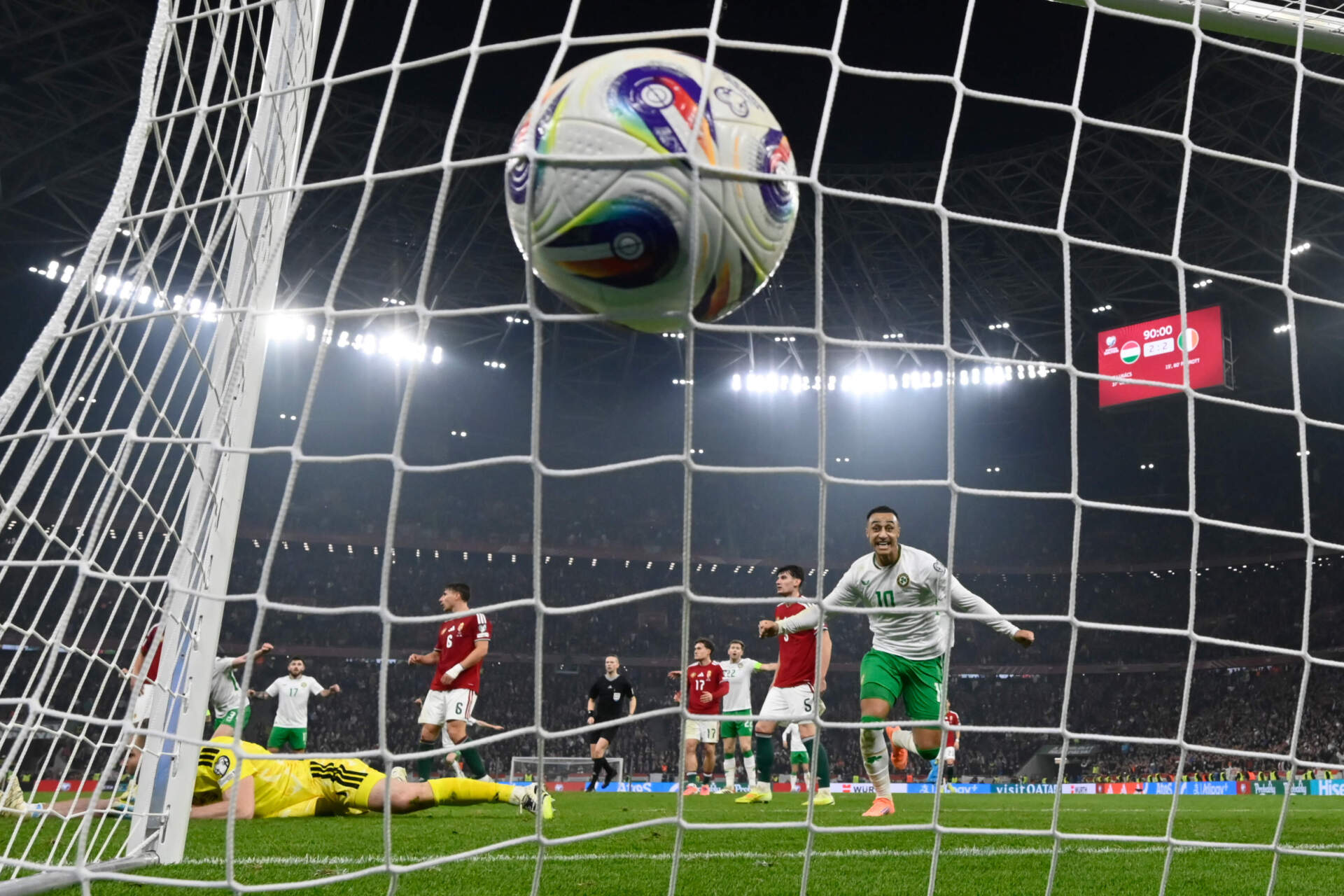 Hungary goalkeeper Denes Dibusz fails to save a shot by Ireland's Troy Parrott who scored his side's third goal during a World Cup 2026 qualifying match. (Denes Erdos/AP)