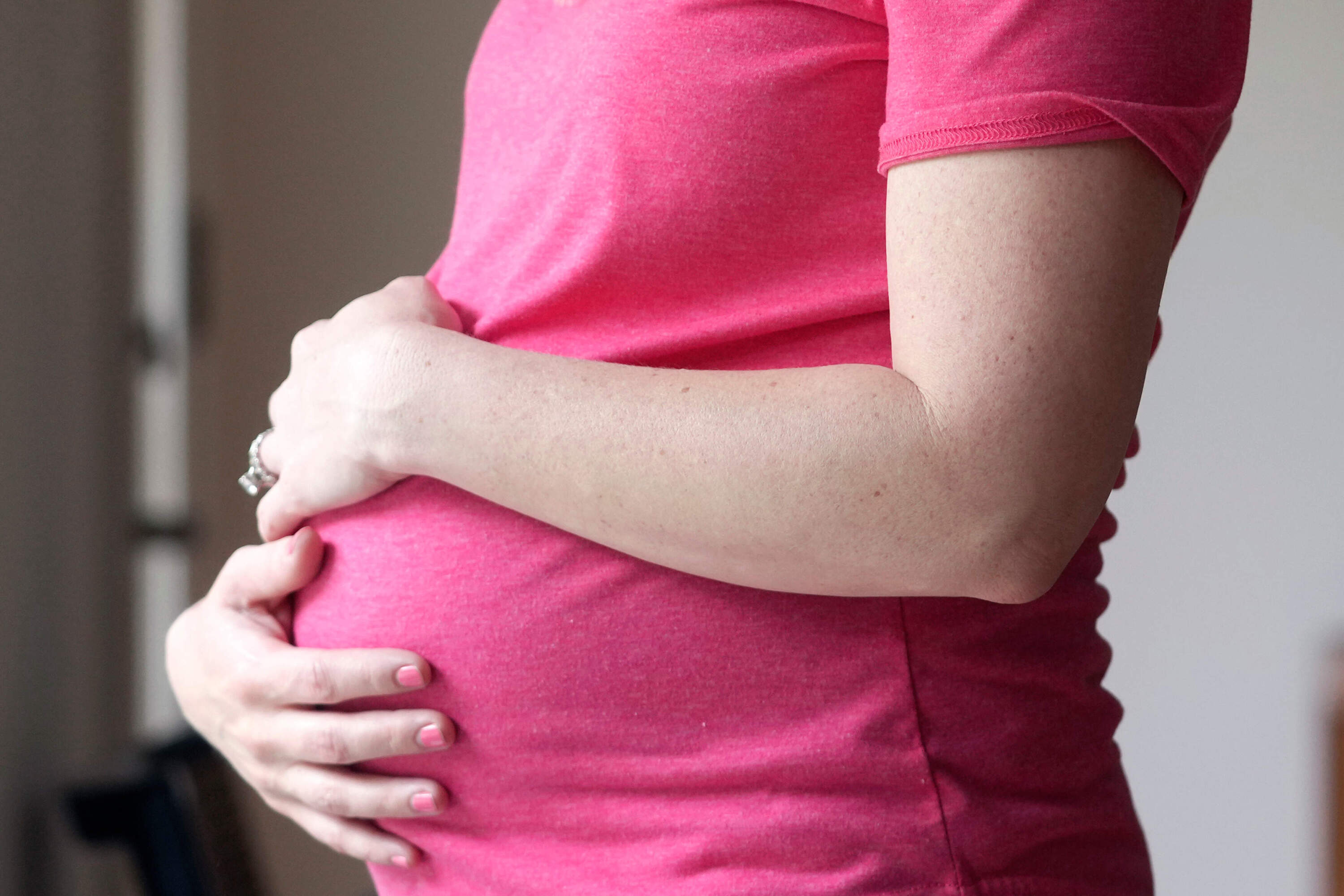 A pregnant woman stands for a portrait in Dallas, May 18, 2023. (LM Otero/AP)