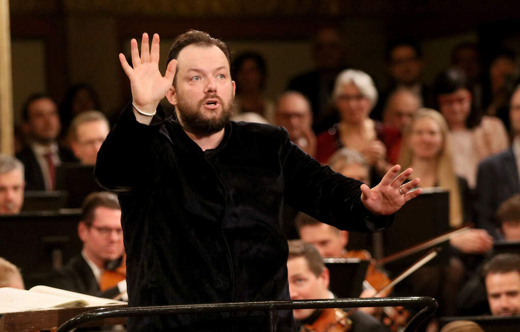 FILE - Latvian conductor Andris Nelsons conducts the Vienna Philharmonic Orchestra during a rehearsal for the traditional New Year's concert at the golden hall of Vienna's Musikverein, in Vienna, Austria, Monday, Dec. 30, 2019. (AP Photo/Ronald Zak, File