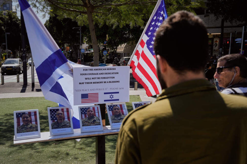 An Israeli soldier looks at a makeshift memorial honoring U.S. servicemembers killed during the war with Iran, in Tel Aviv, Israel, on March 10. (Baz Ratner/ AP)