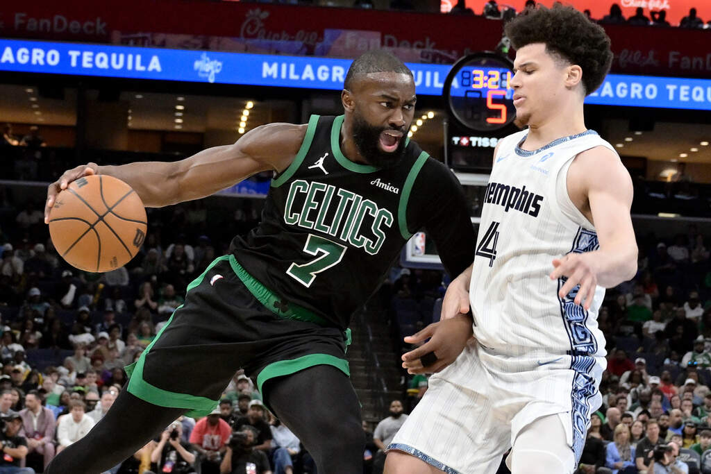 Boston Celtics guard Jaylen Brown (7) drives against Memphis Grizzlies guard Walter Clayton Jr. (4) in the second half of an NBA basketball game Friday, March 20, 2026, in Memphis, Tenn. (AP Photo/Brandon Dill)
