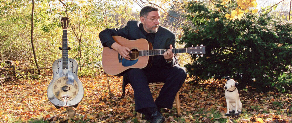 Bob Franke with steel guitar and dog. (Courtesy)