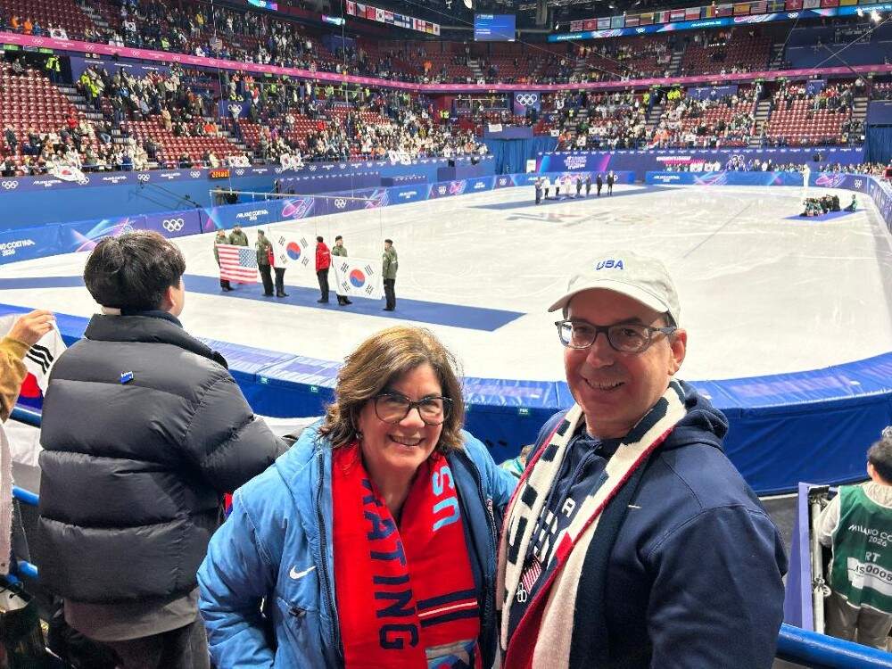 The author and her husband at the 1500-meter medal ceremony for short track speed skating at the 2026 Milano Cortina Olympics. (Courtesy Jean Letai)