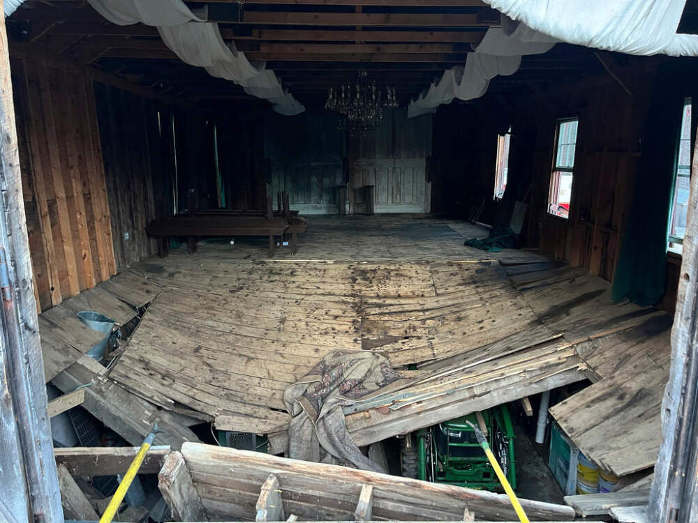 A photo provided by the New Hampshire State Fire Marshal's Office shows the buckled floor that collapsed Saturday, sending nearly 70 wedding guests into the basement of a building in Tamworth, N.H. Saturday, March 21, 2026. (New Hampshire State Fire Marshal's Office via AP)