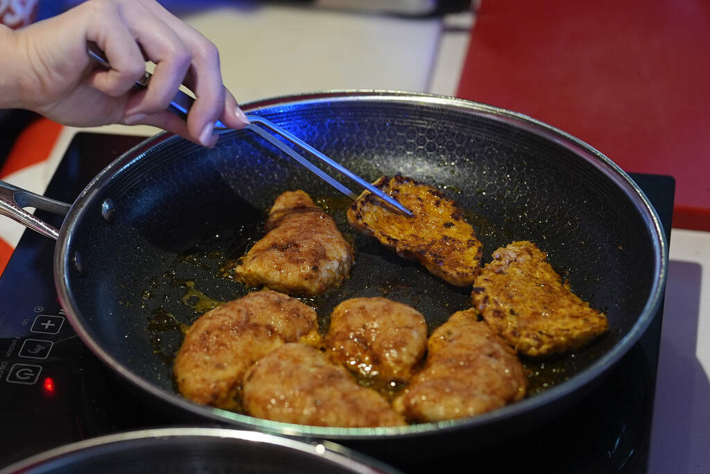 A chef cooks cultivated chicken at a Miami pop-up tasting for