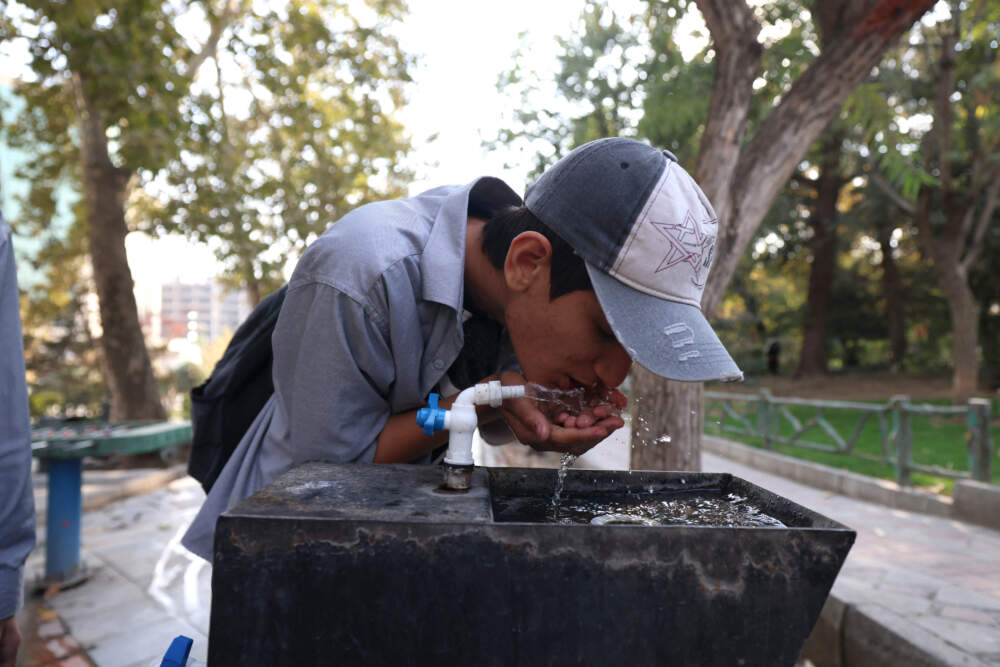 A youth drinks water from a fountain in Mellat Park in Tehran on Nov. 9, 2025. (Photo by Atta Kenare/AFP via Getty Images)