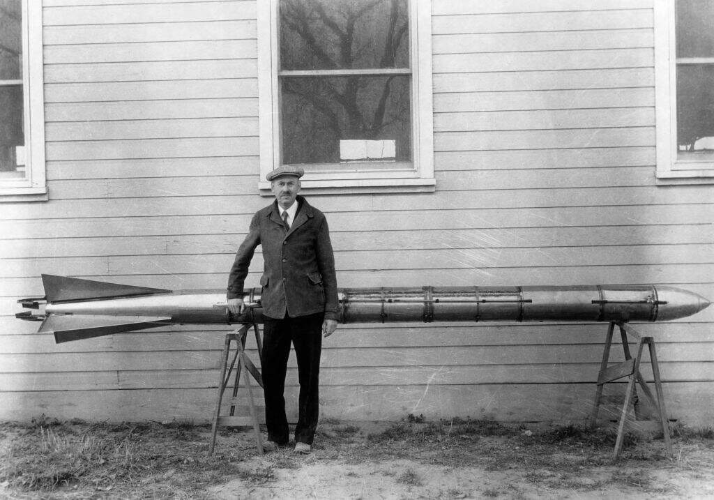 Portrait of Robert Goddard (1882 - 1945) standing with a rocket that was successfully tested at Roswell, New Mexico on March 28, 1935. (Photo by Esther Goddard/Hulton Archive/Getty Images)