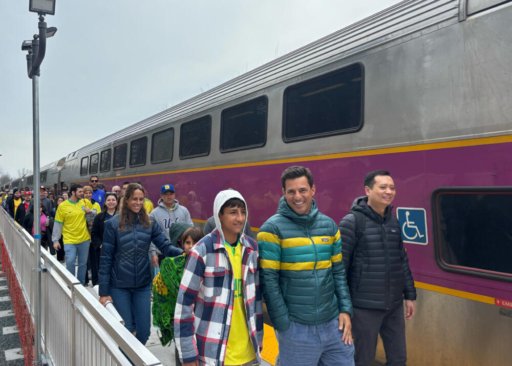 Attendees file off the train at Foxboro Station ahead of the friendly match between France and Brazil at Gillette Stadium March 26, 2026. (Katie Cole/WBUR)