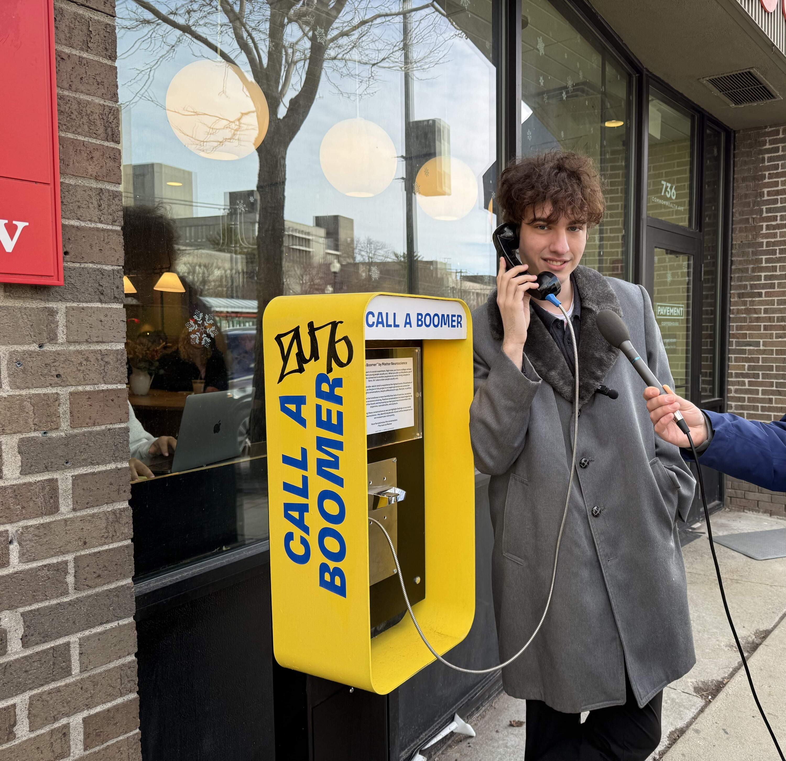 Ryan Marcantonio uses the Boston payphone. (Michael Scotto/Here &amp; Now)