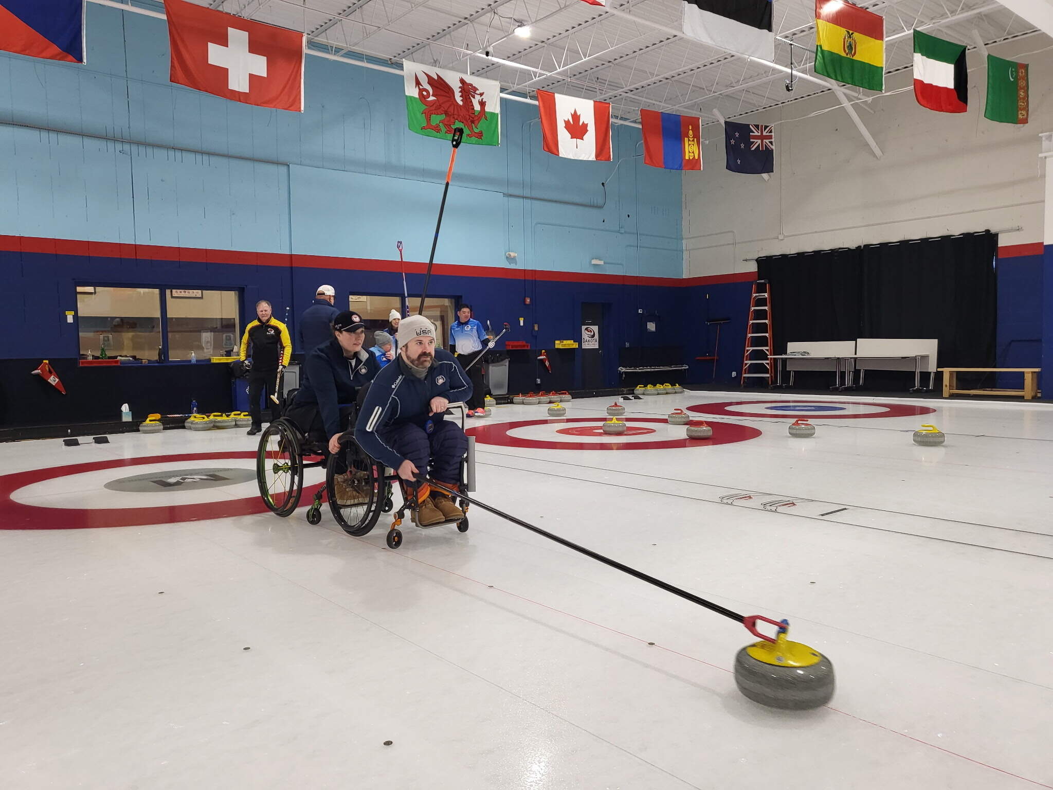 Sean O'Neill (center) prepares to throw a stone during practice ahead of the Paralympics. (Courtesy of Oyuna Uranchimeg)
