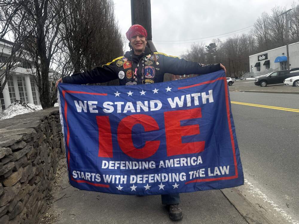 Counterprotester Laura Simpson stands in front of Cafe Escadrille in Burlington. (Simón Rios/WBUR)