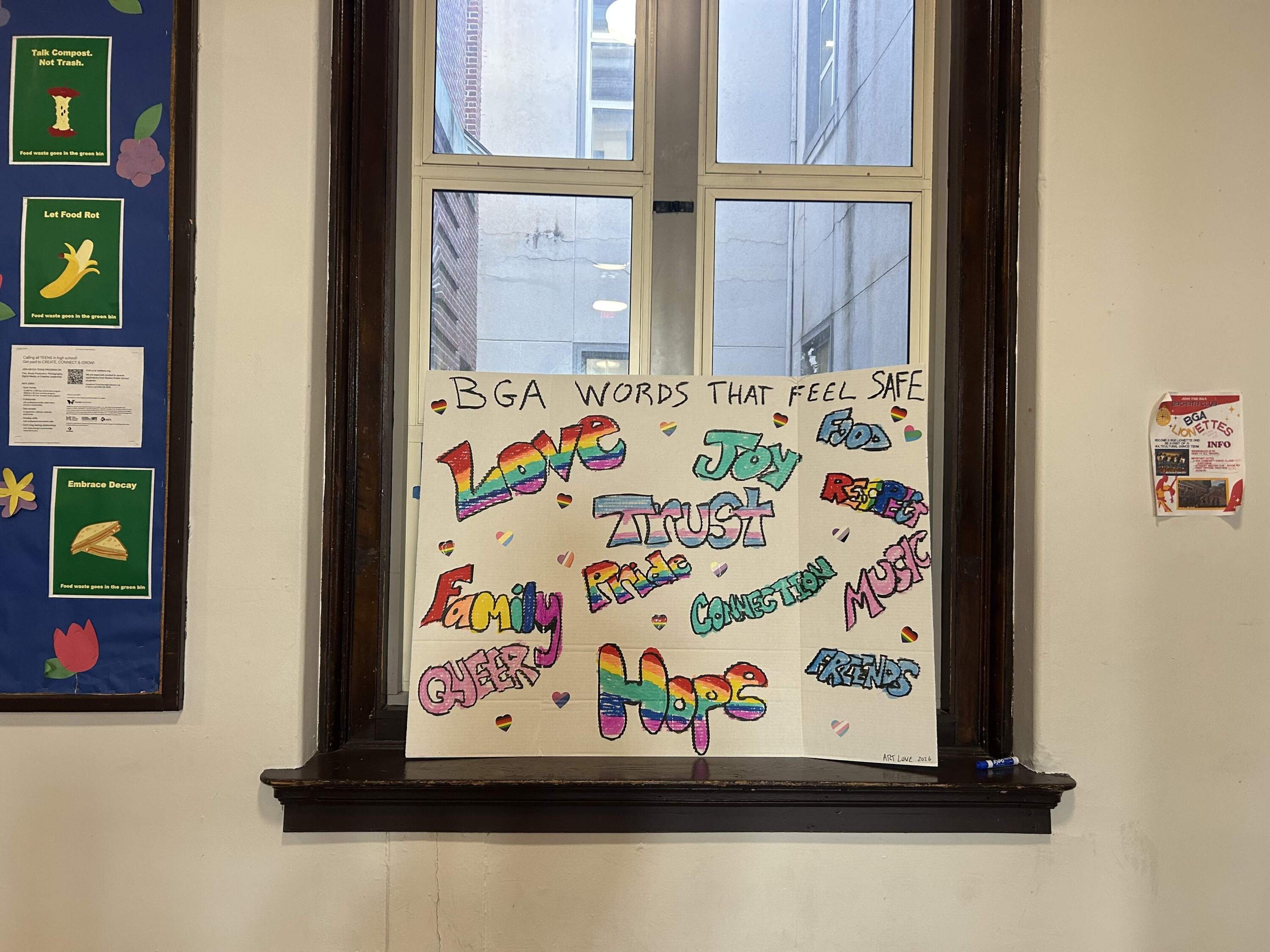 A sign designed by a member of the Art Love club sits in the lobby of Boston Green Academy. (Amanda Beland/WBUR)
