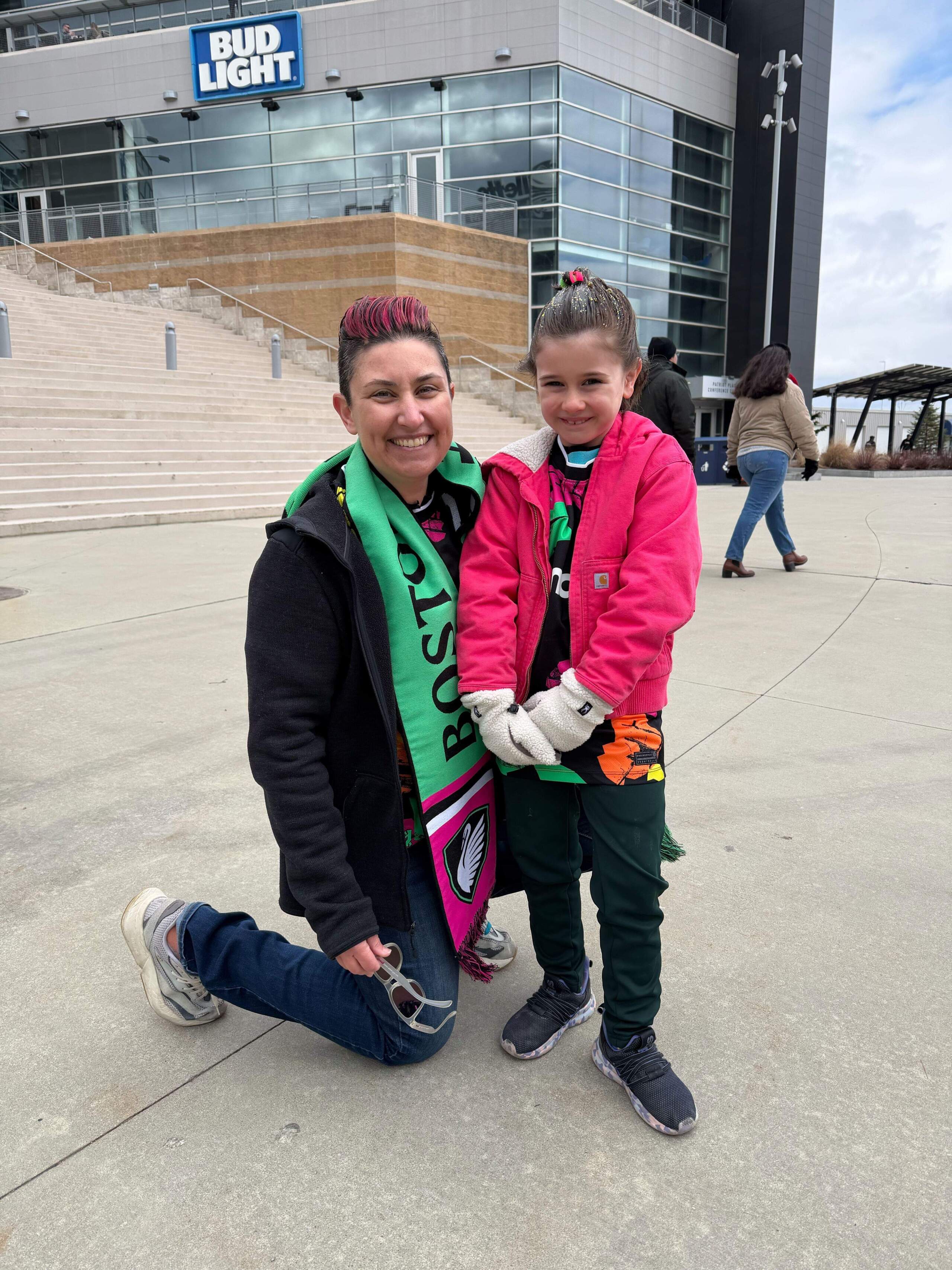 Sarah Toce and her daughter, Hannah, stand outside of Gillette Stadium during Saturday's home opener. (Amy Sokolow/WBUR)