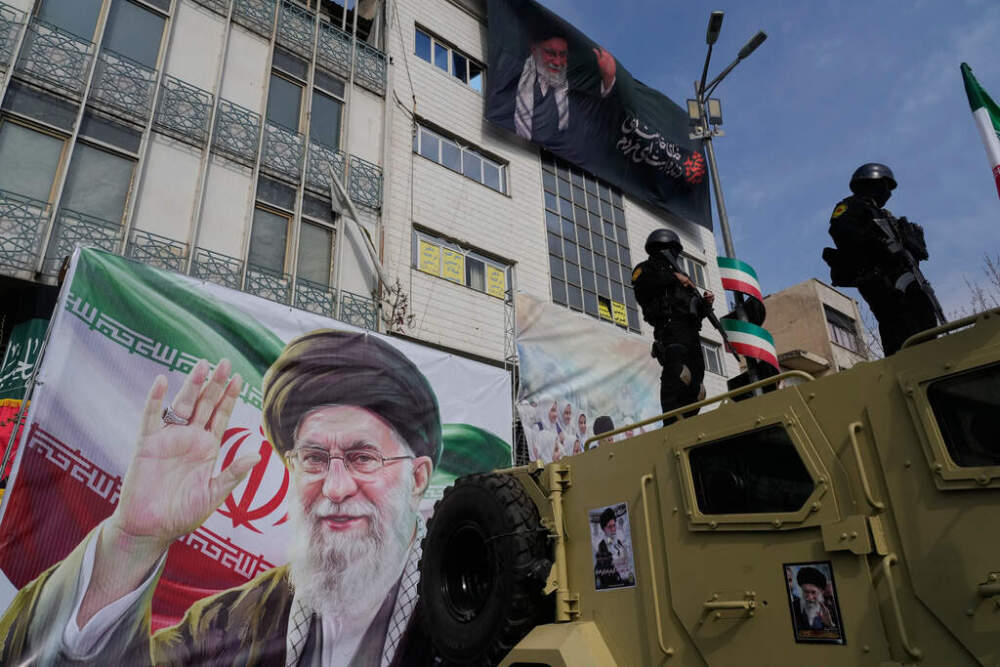 Policemen stand on top of their car during a rally to support Ayatollah Mojtaba Khamenei, the successor to his late father Ayatollah Ali Khamenei, shown in the banners, as supreme leader, in Tehran, Iran, Monday, March 9, 2026. (AP Photo/Vahid Salemi)
