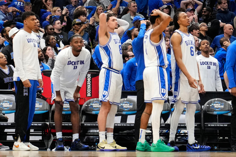 Duke players react to their loss against UConn in the Elite Eight of the NCAA college basketball tournament. (Abbie Parr/AP)