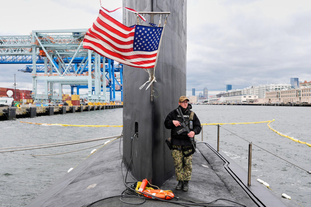 A sailor stands guard next to the sail of the USS Massachusetts, the Navy's newest nuclear-powered attack submarine, Friday, March 27, 2026, in Boston. (Robert F. Bukaty/AP)