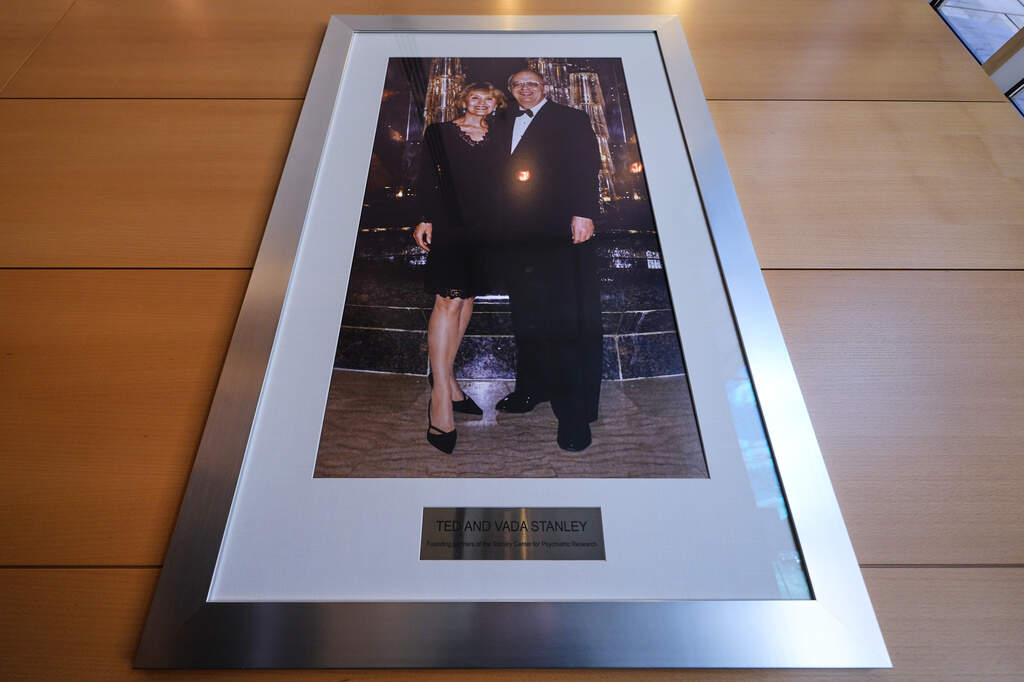 A portrait of Ted and Vada Stanley hangs in the lobby of the Broad Institute, which houses the Stanley Center for Psychiatric Research. (Charles Krupa/AP)