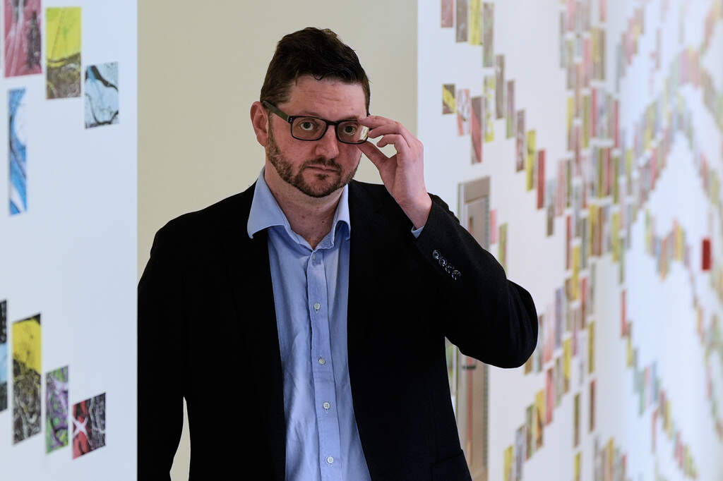 Benjamin Neale, co-director of the Stanley Center for Psychiatric Research, poses for a portrait near laboratory space at the Broad Institute in Cambridge. (Charles Krupa/AP)