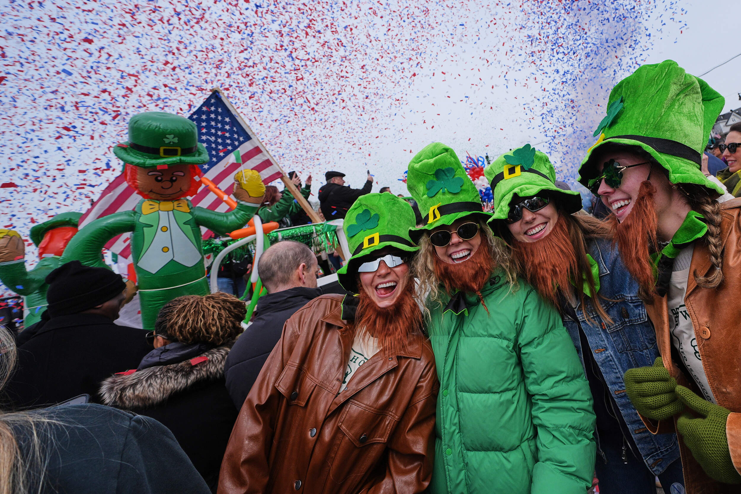 Spectators wearing leprechaun hats and beards smile as confetti cannons blast during the annual St. Patrick's Day parade, March 15, 2026, in Boston. (Charles Krupa/AP)