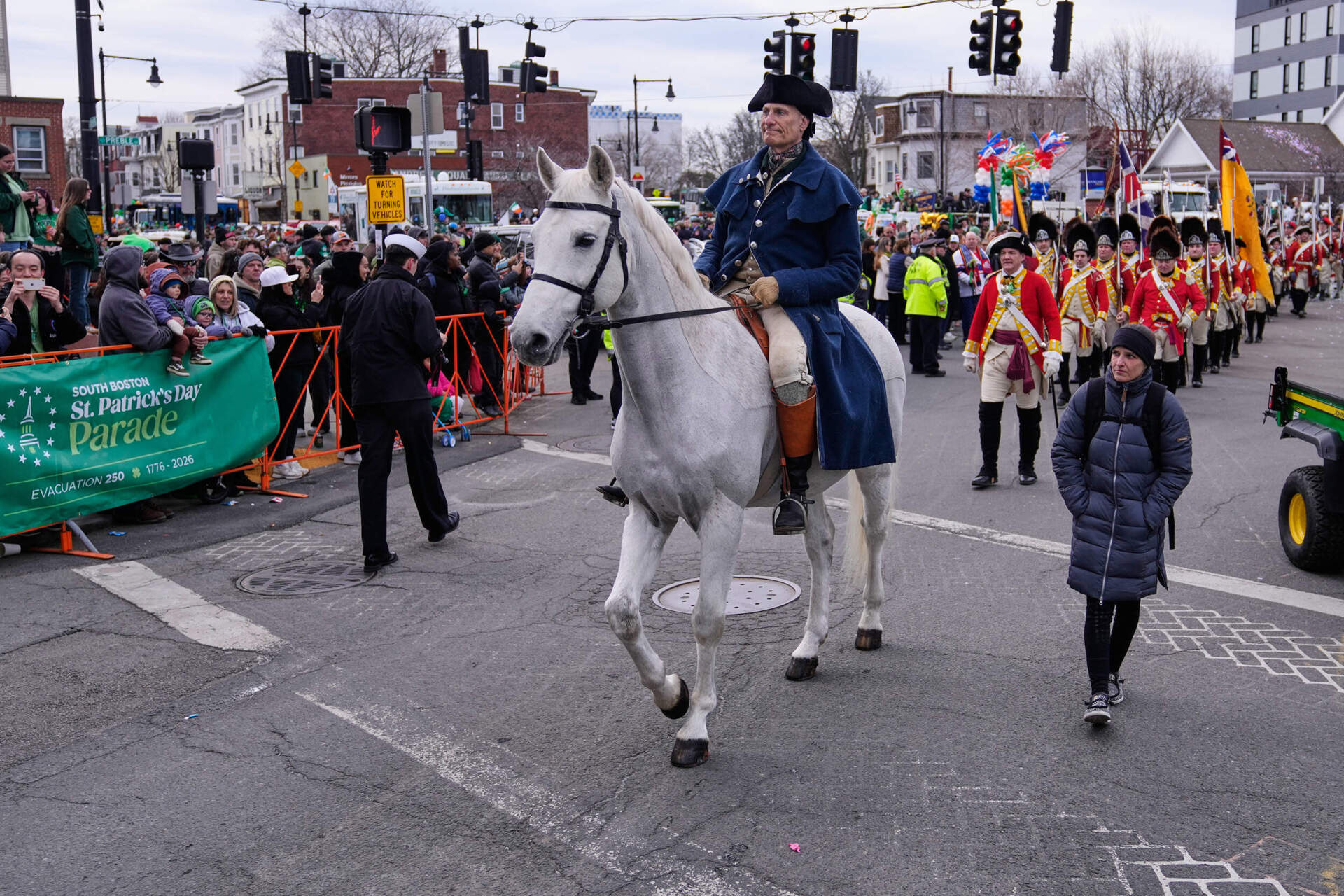 A rider portraying Paul Revere is followed by re-enactors marching as Revolutionary War British soldiers in red coats during the annual St. Patrick's Day/Evacuation Day parade in Boston. (Charles Krupa/AP)
