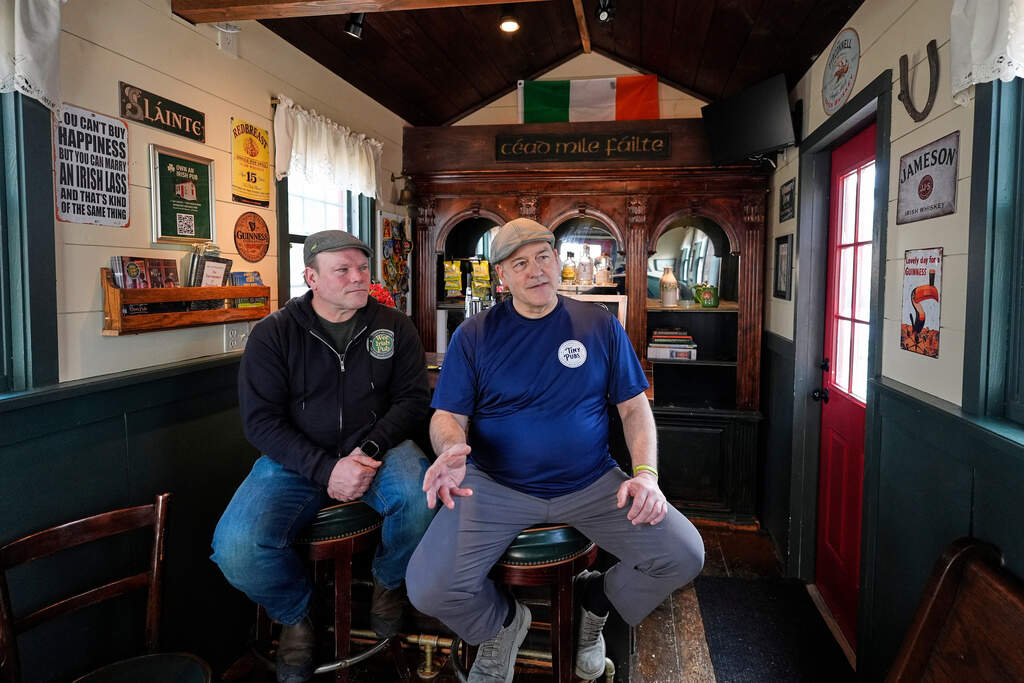Brothers Matt Taylor, left, and Craig Taylor talk with a visitor in one of their tiny pubs Wednesday, March 11, 2026, in Reading, Mass. (Robert F. Bukaty/AP)