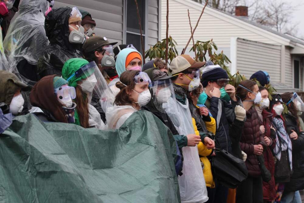 Protesters prepare for the arrival of Vermont State Police and ICE agents outside a South Burlington home where an ICE arrest was planned. (Zoe McDonald/Vermont Public)