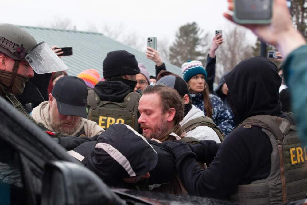Federal officers and Vermont State Police arrested protesters outside a South Burlington home where officers made arrests. (Zoe McDonald/Vermont Public)