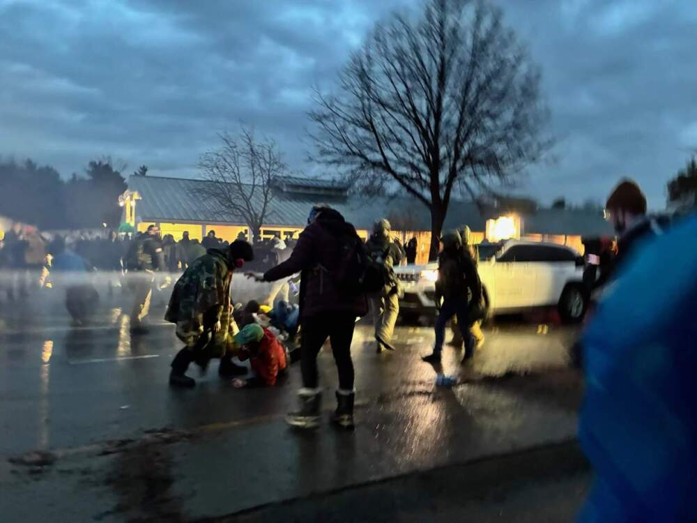 Police resorted to using flash bangs and tear gas on a crowd of protesters who were attempted to prevent law enforcement vehicles from leaving the scene of the Dorset Street house in South Burlington. (Zoe McDonald/Vermont Public)