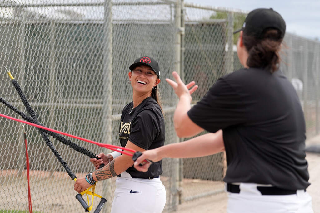 Kelsie Whitmore talks with another player as they use resistance bands during a Women's Pro Baseball League (WPBL) practice, Wednesday, March 18, 2026, in Fort Myers, Fla. (Rebecca Blackwell/AP)