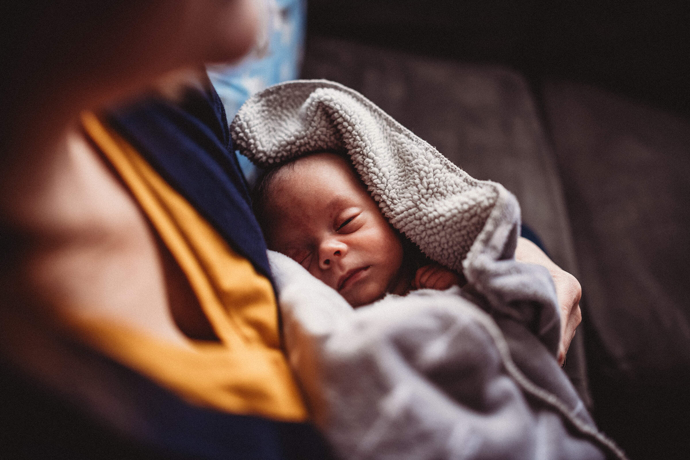 A 1-month-old baby sleeps in his mother's arms. (Jill Lehmann/Getty Images)