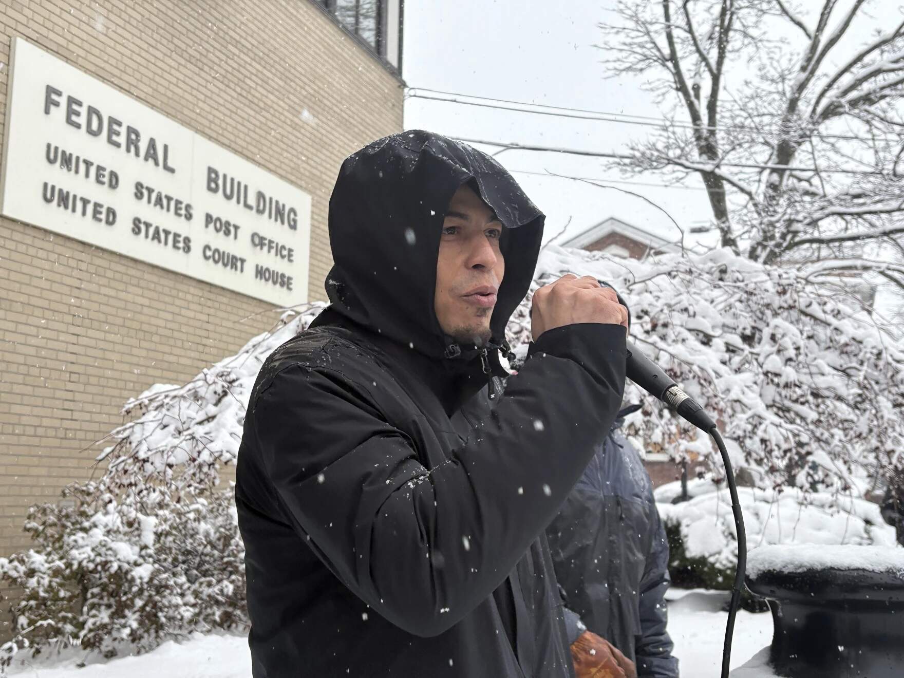 Christian Jerez Andrade thanks activists during a rally outside the federal courthouse in Burlington on Friday, March 20. (Derek Brouwer/Vermont Public)